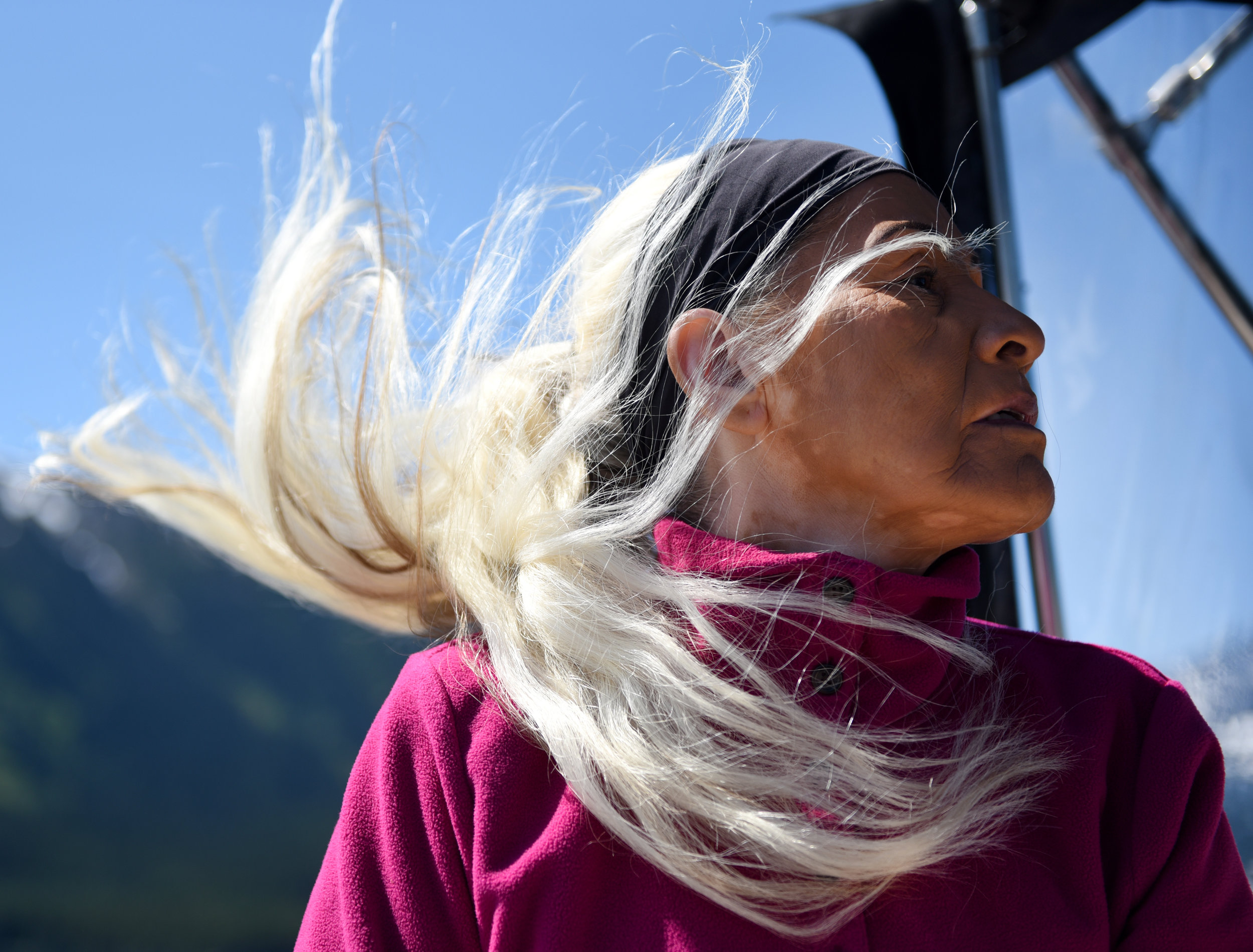 Gloria Alexis looks over the front of the boat as it speeds across Eutsuk Lake on July 18, 2017 in British Columbia, Canada. 