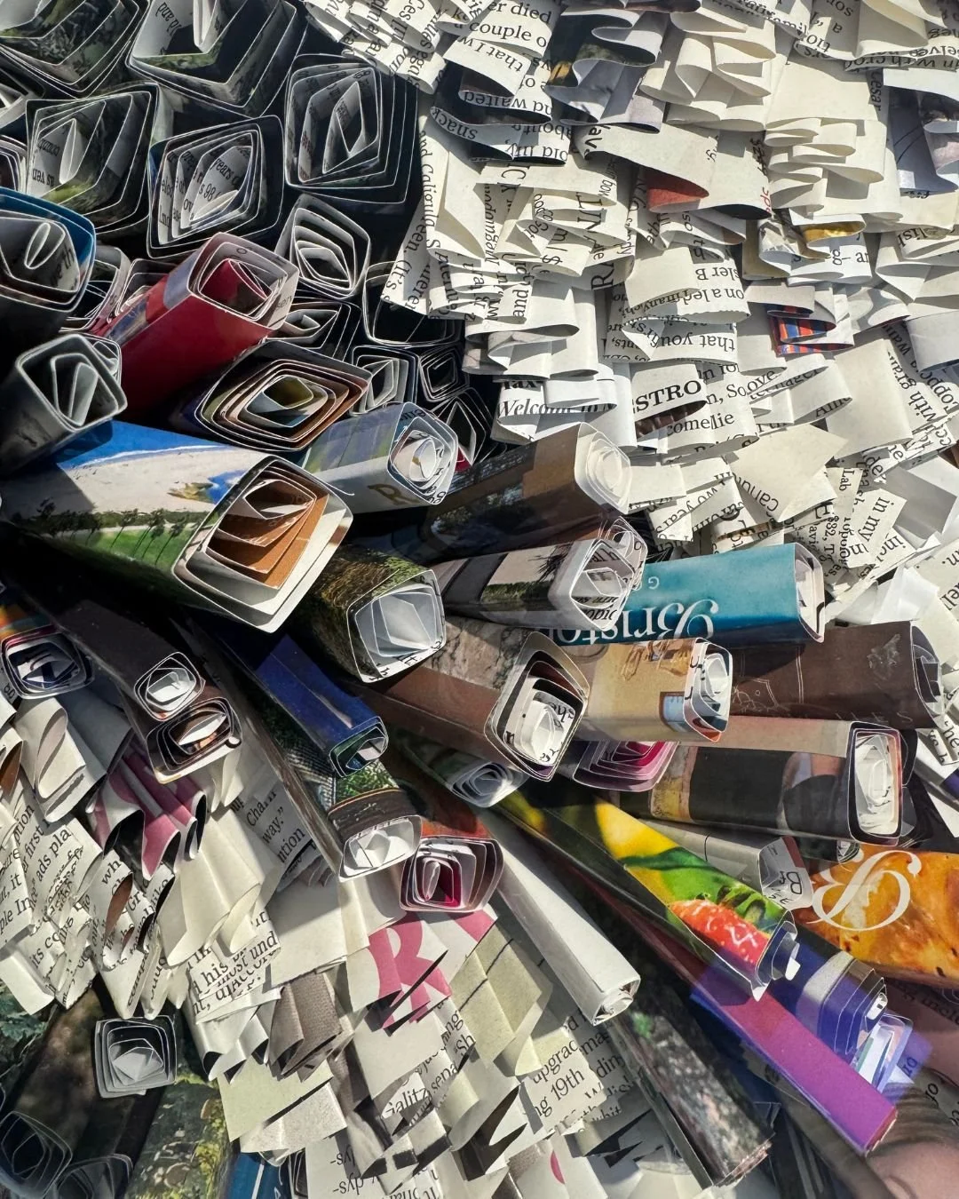a detail image of layered folds and rolls of recycled magazines of the larger original paper art Metropolis by marilyn mcrae