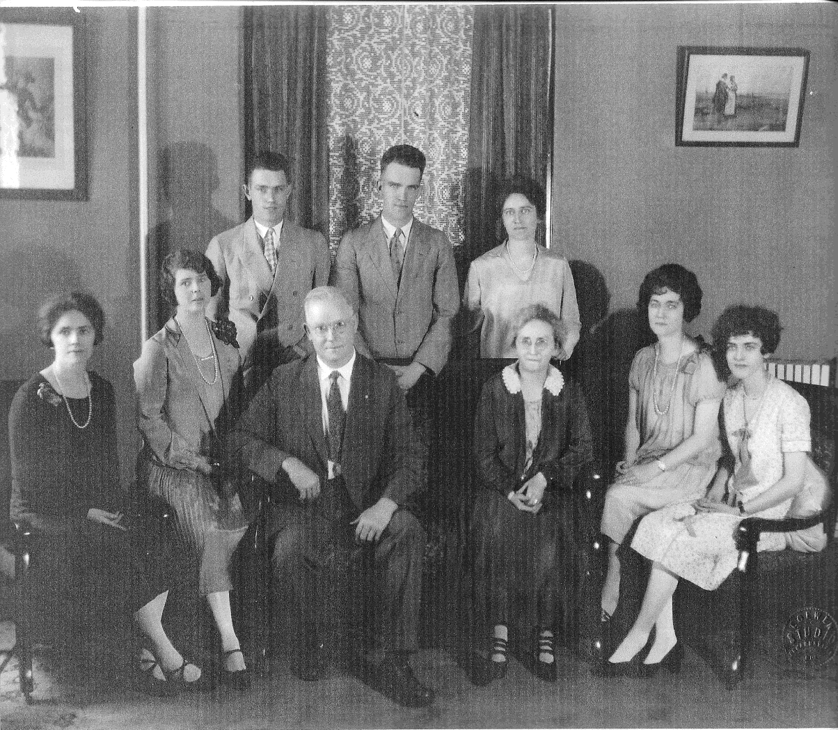   In this undated portrait the members of the Shaw family are: (from left, front) row) Laura Shaw Crossman, Irene Shaw Miller, William Shaw, Elizabeth Reisel Shaw, Mildred Shaw Briggs, Ruth Shaw Smith; (back row) Evan Shaw, Kenneth Shaw, Edith Shaw M