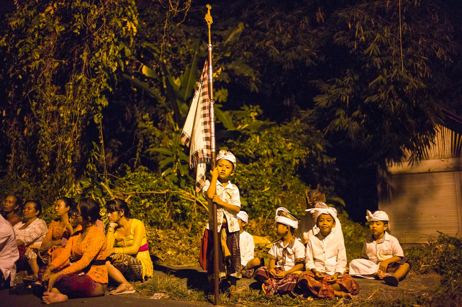 A young boy holds the ceremonial flag