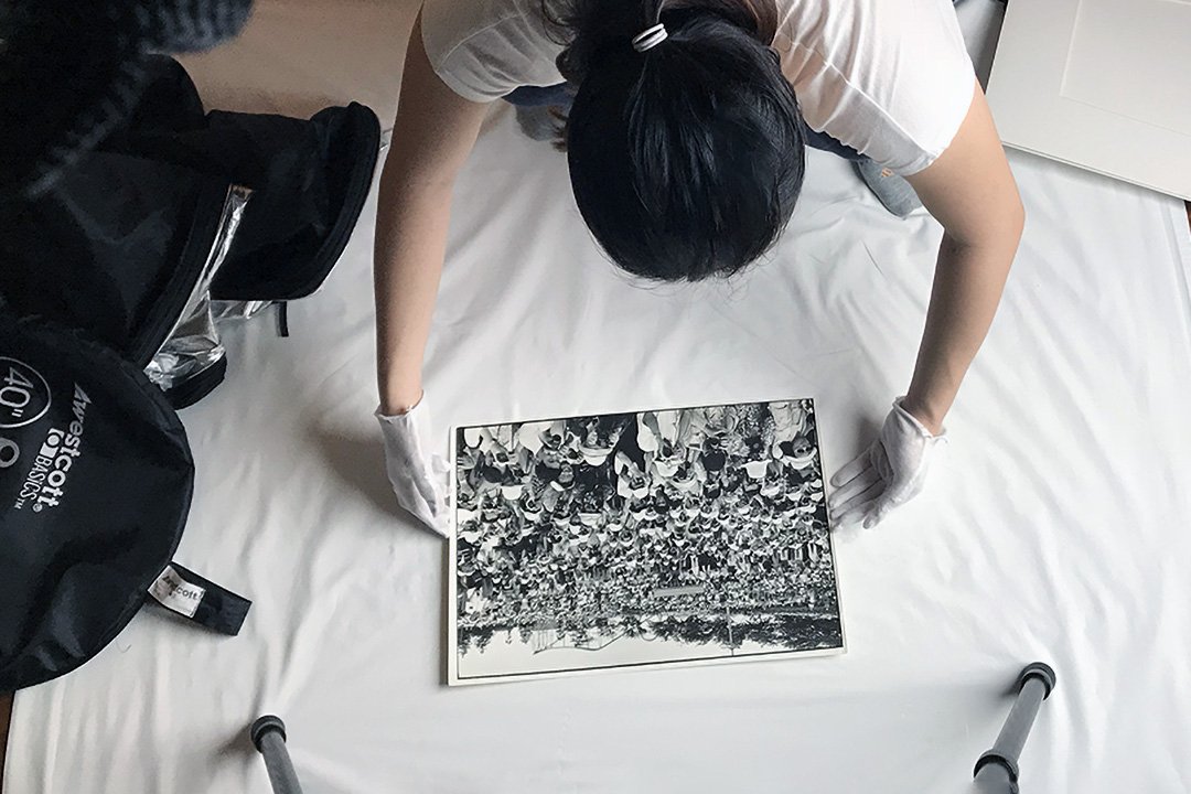 Jamie Chan adjusting a fine art print