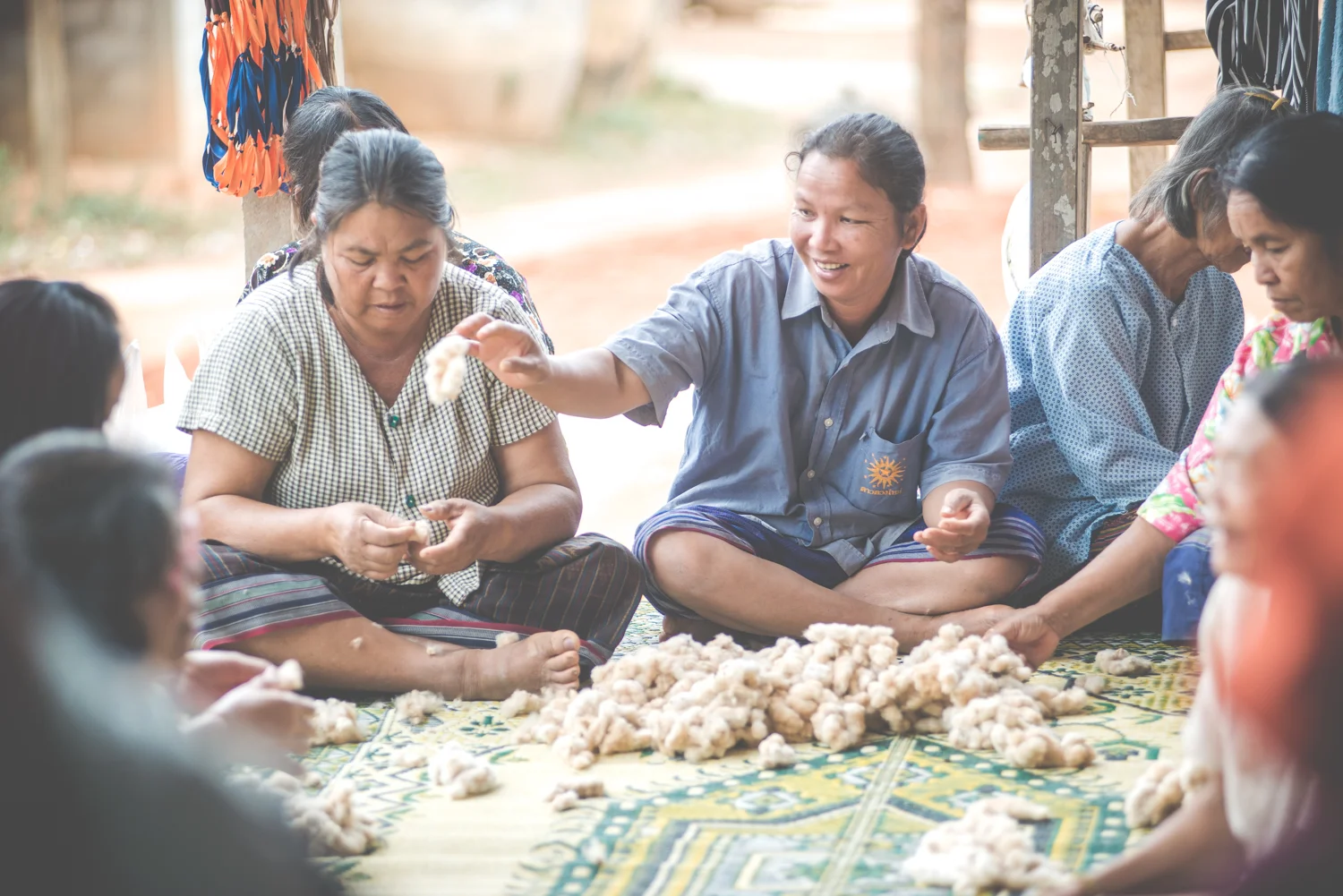 The grandmas love to hang out but their hands are never idle! Preparing hand-grown cotton to be spun is much more fun when friends are near. PC: Louis Bryant