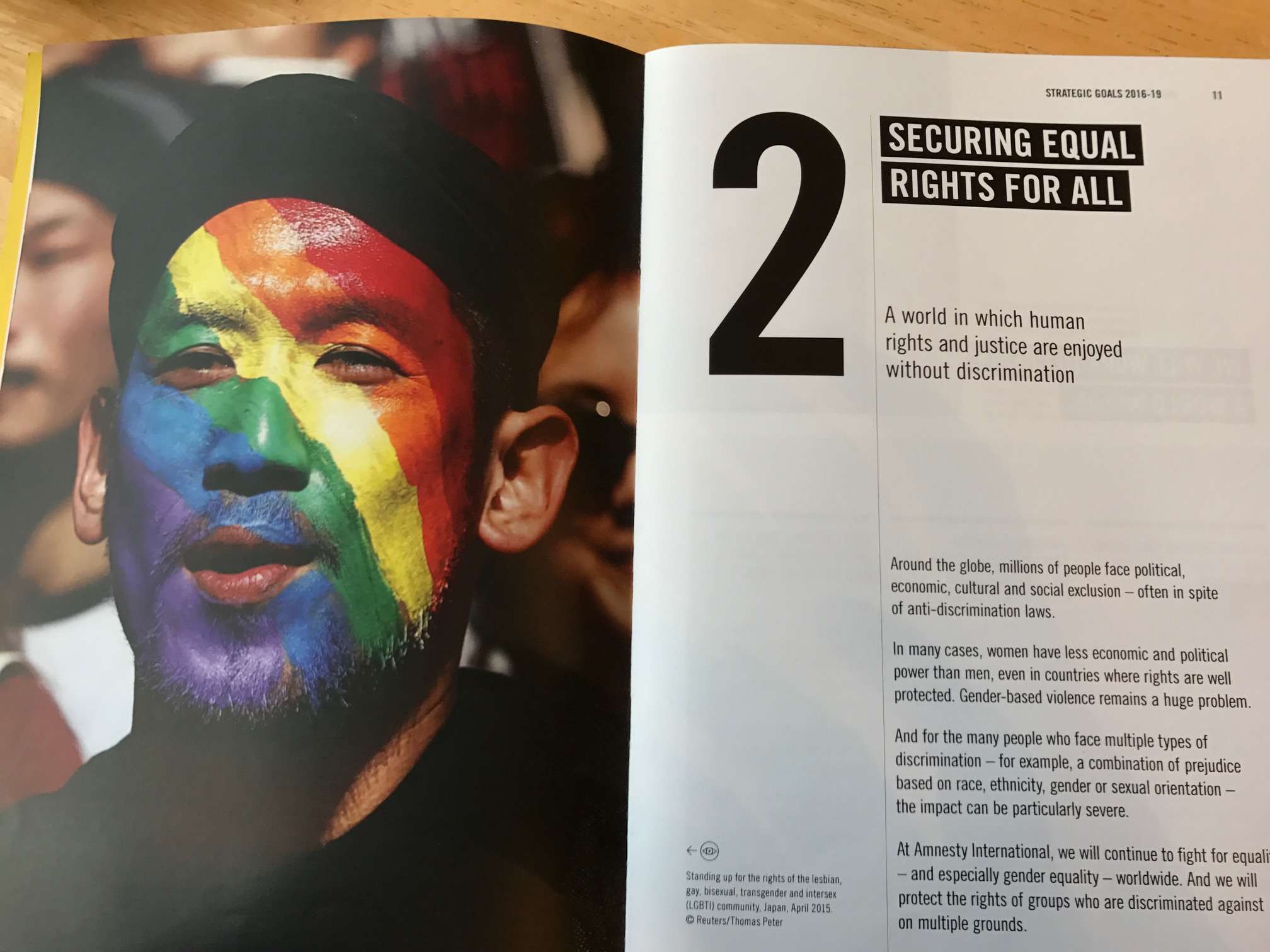 A campaigner with rainbow facepaint to illustrate Amnesty's goal of achieving equality for everyone.