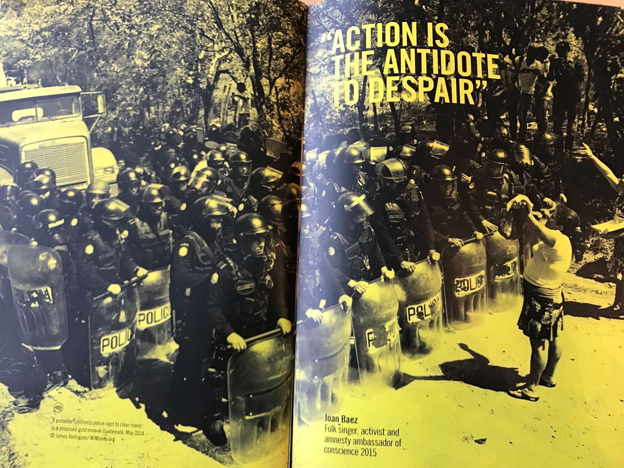 A Joan Baez quote, 'Action is the antidote to despair' to illustrate a protestor standing up to riot police.