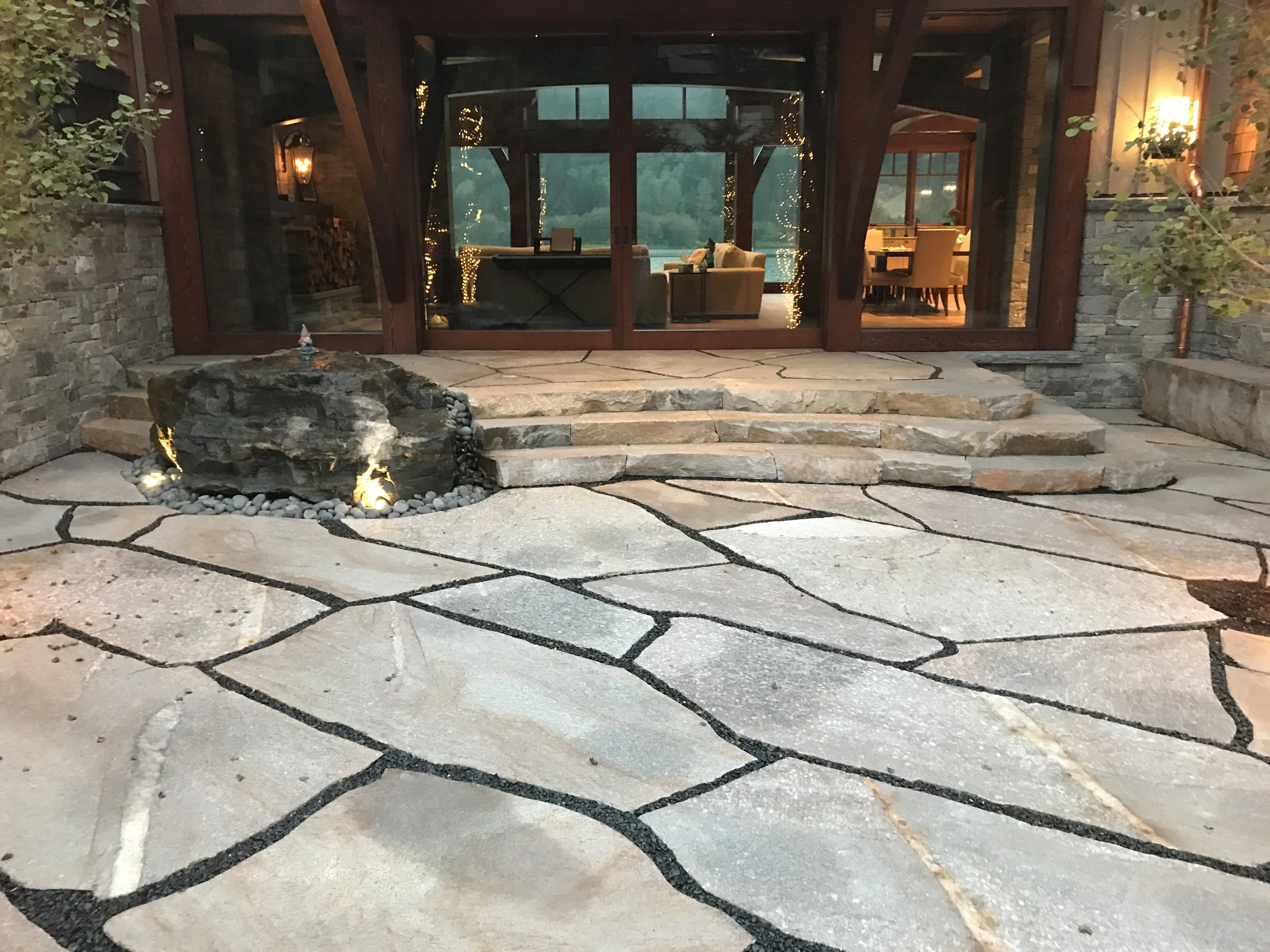 21. Granite front steps with water feature to left
