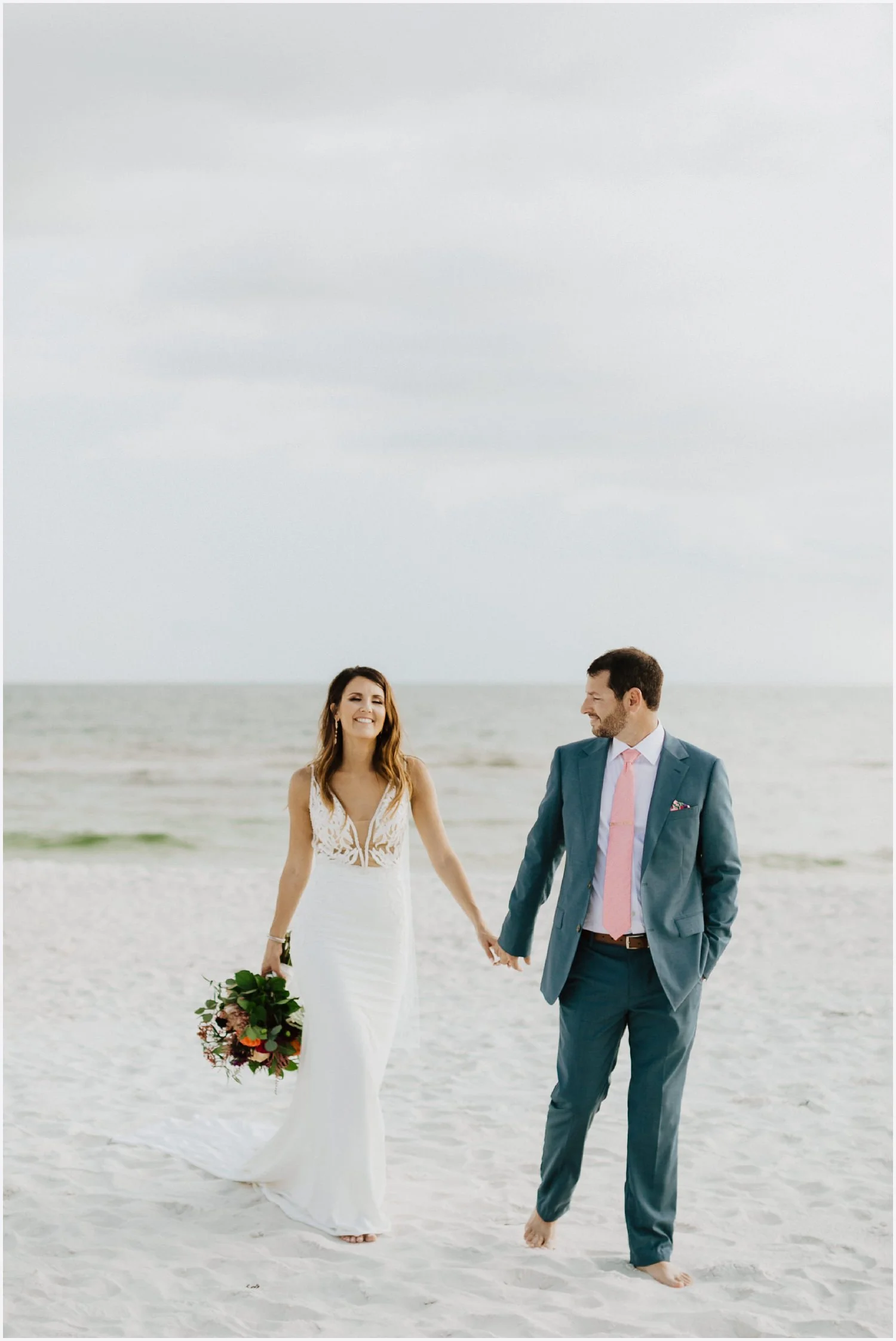 Bride and groom walking on Rosemary Beach
