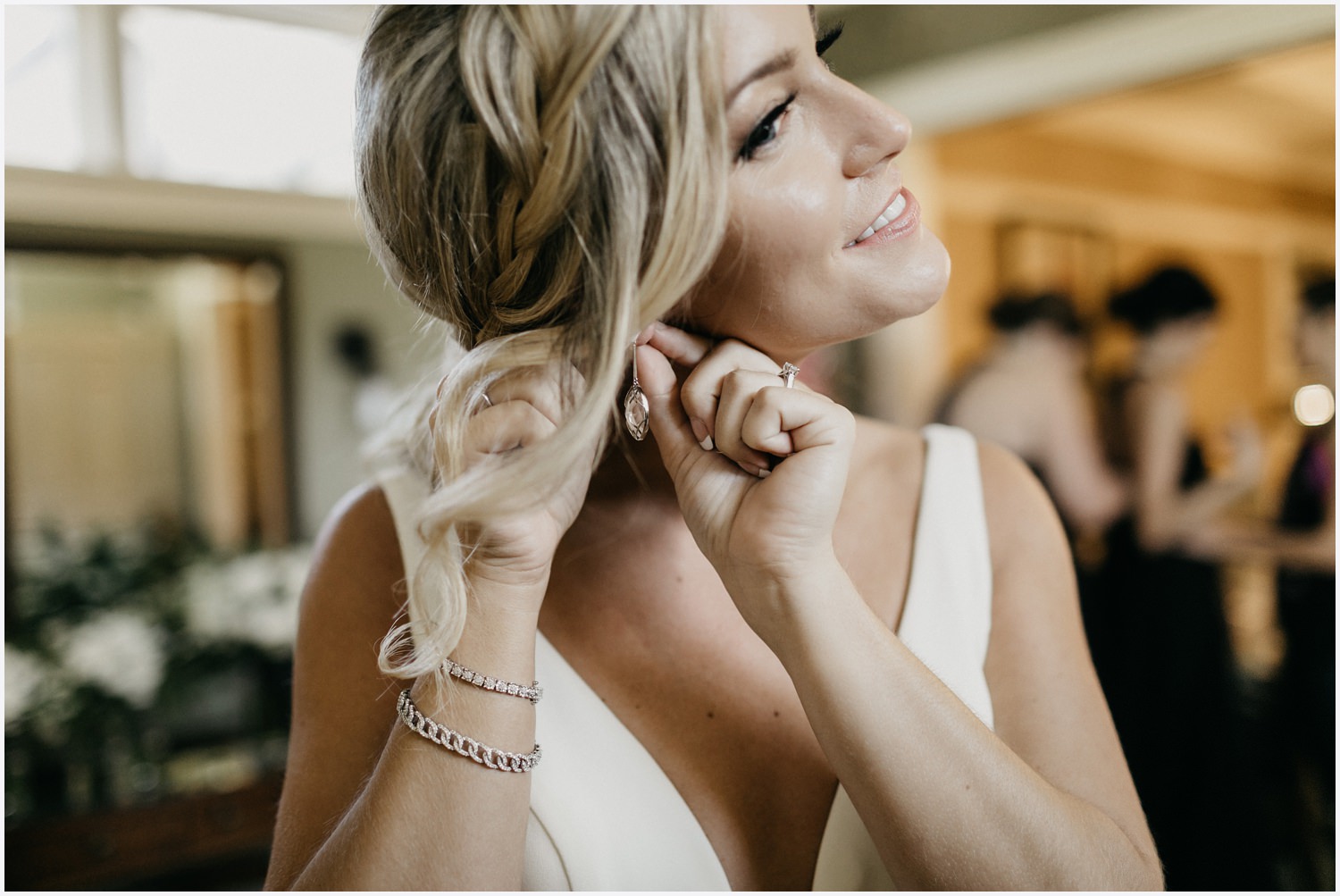 Bride putting her wedding jewelry on at the Shark's Tooth Golf Club