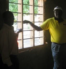 The Pastor of the church showing the newly installed windows!
