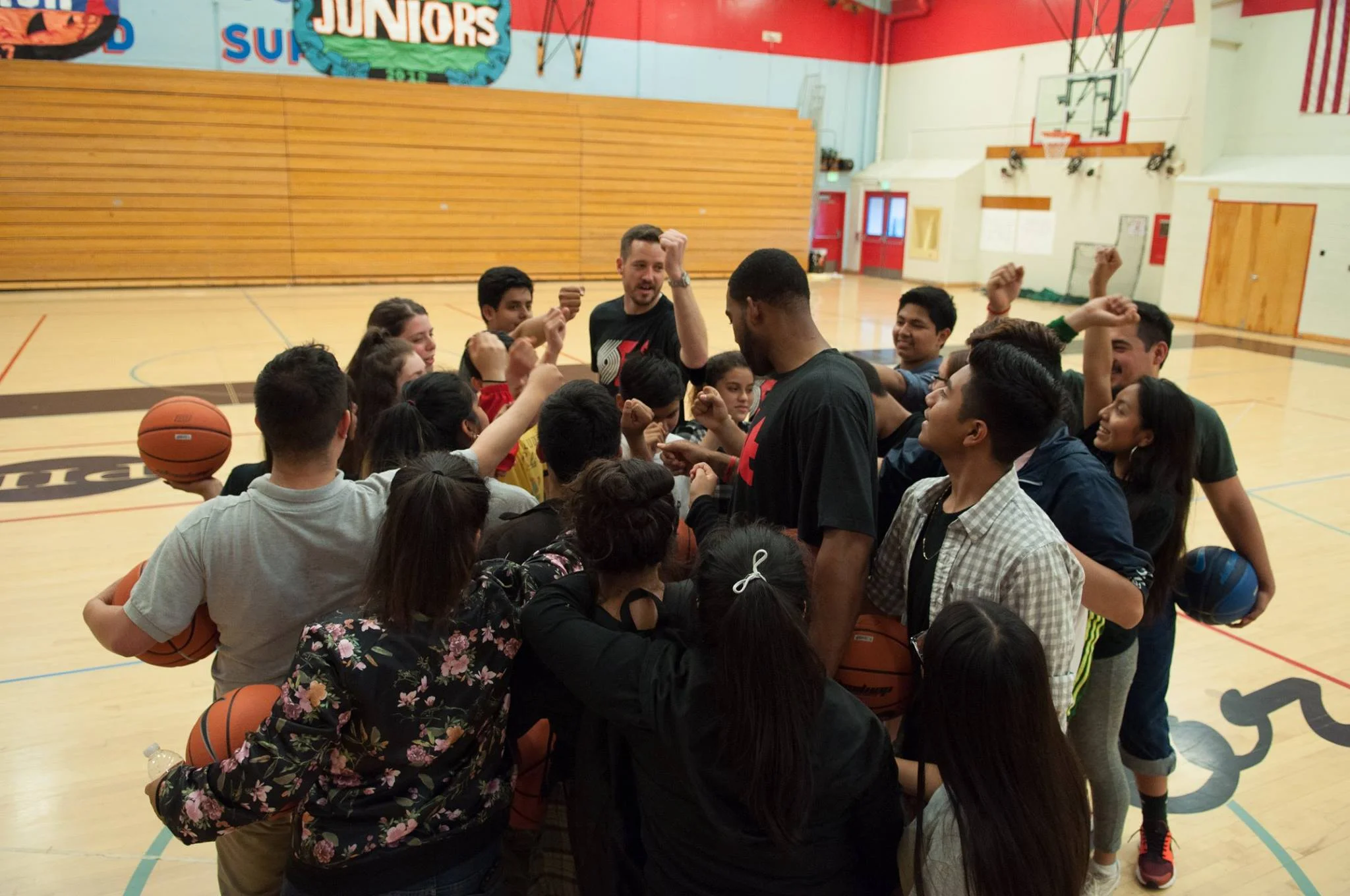 Madison High School Ninth Grade Counts students huddle up after a Portland Trail Blazers basketball clinic.