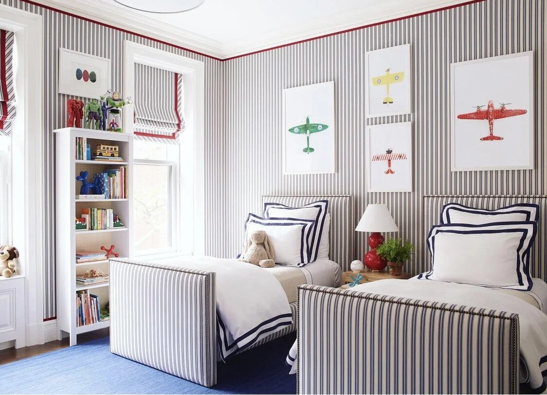 We can’t get over this room with our airplanes. The pattern repeat on the beds are window treatments are done to perfection. Ashley is excellent at the small details in her designs like the nail trim on the beds and the the red trim that elevates th…