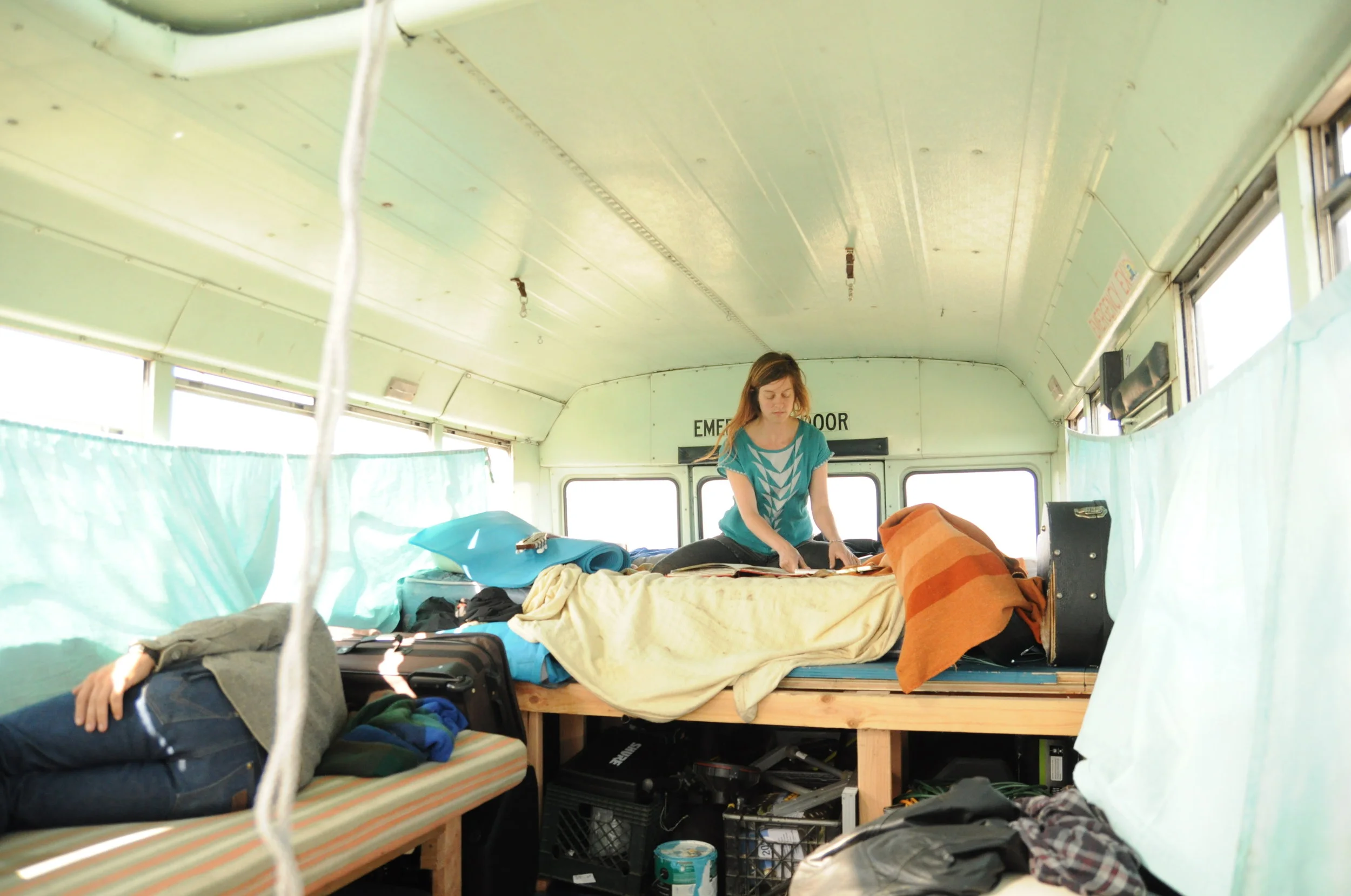 Angela does some art on the impossible back-of-the-bus mattress