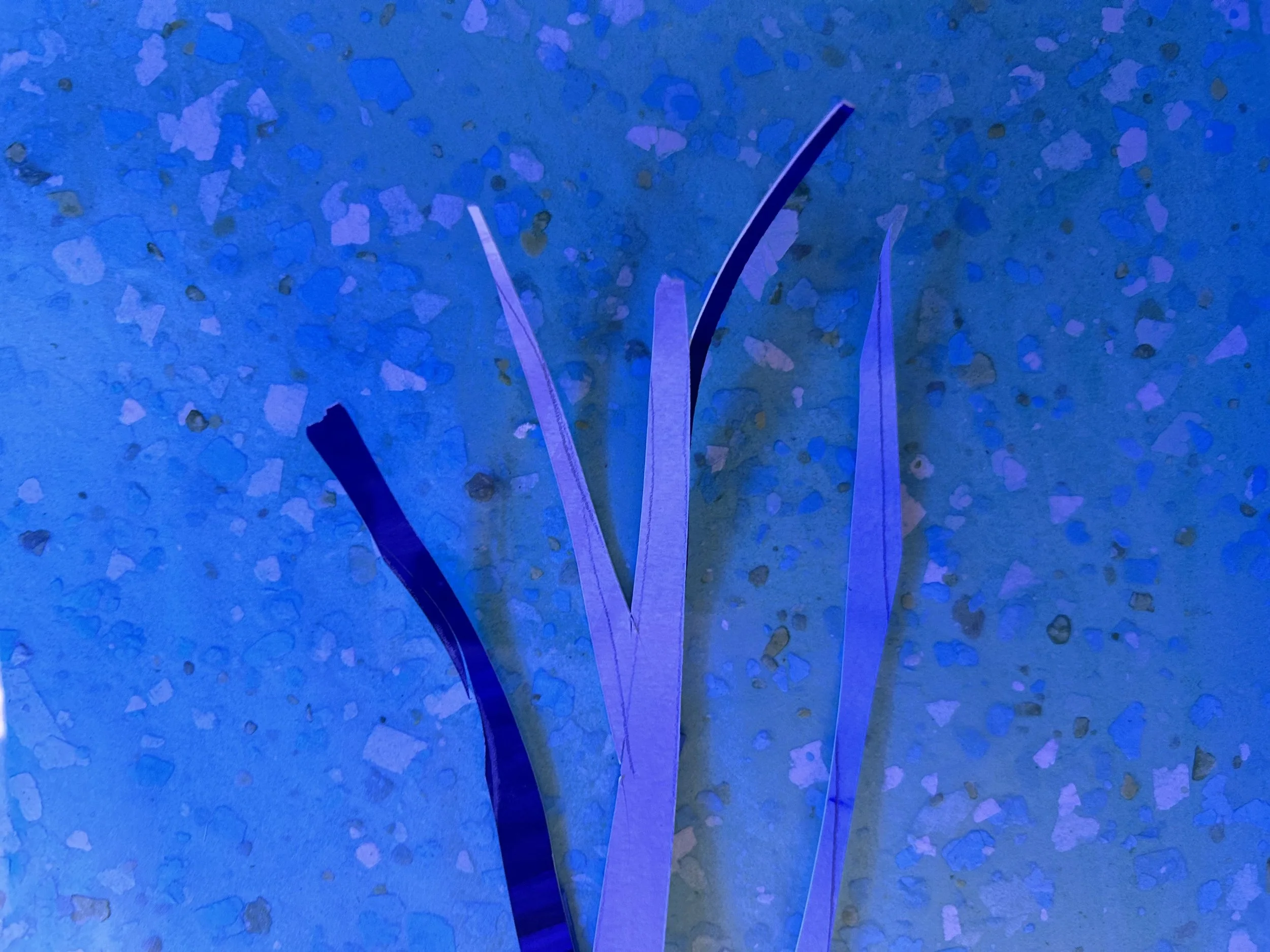 Tree branch elements in progress — cut paper strips in indigo and lavender against a painted ground.