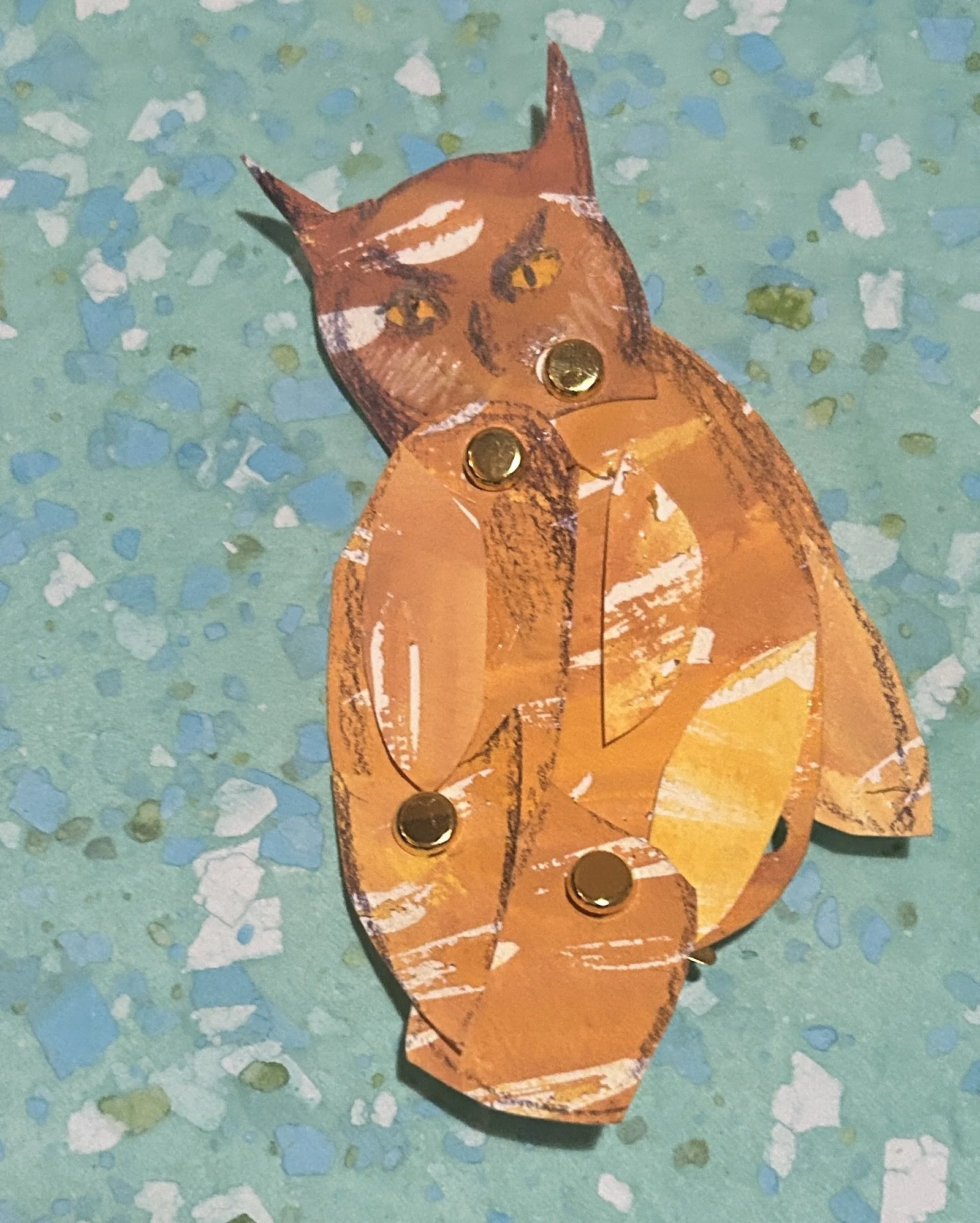 The owl puppet — hand-drawn and painted, jointed with brass brads for frame-by-frame articulation.