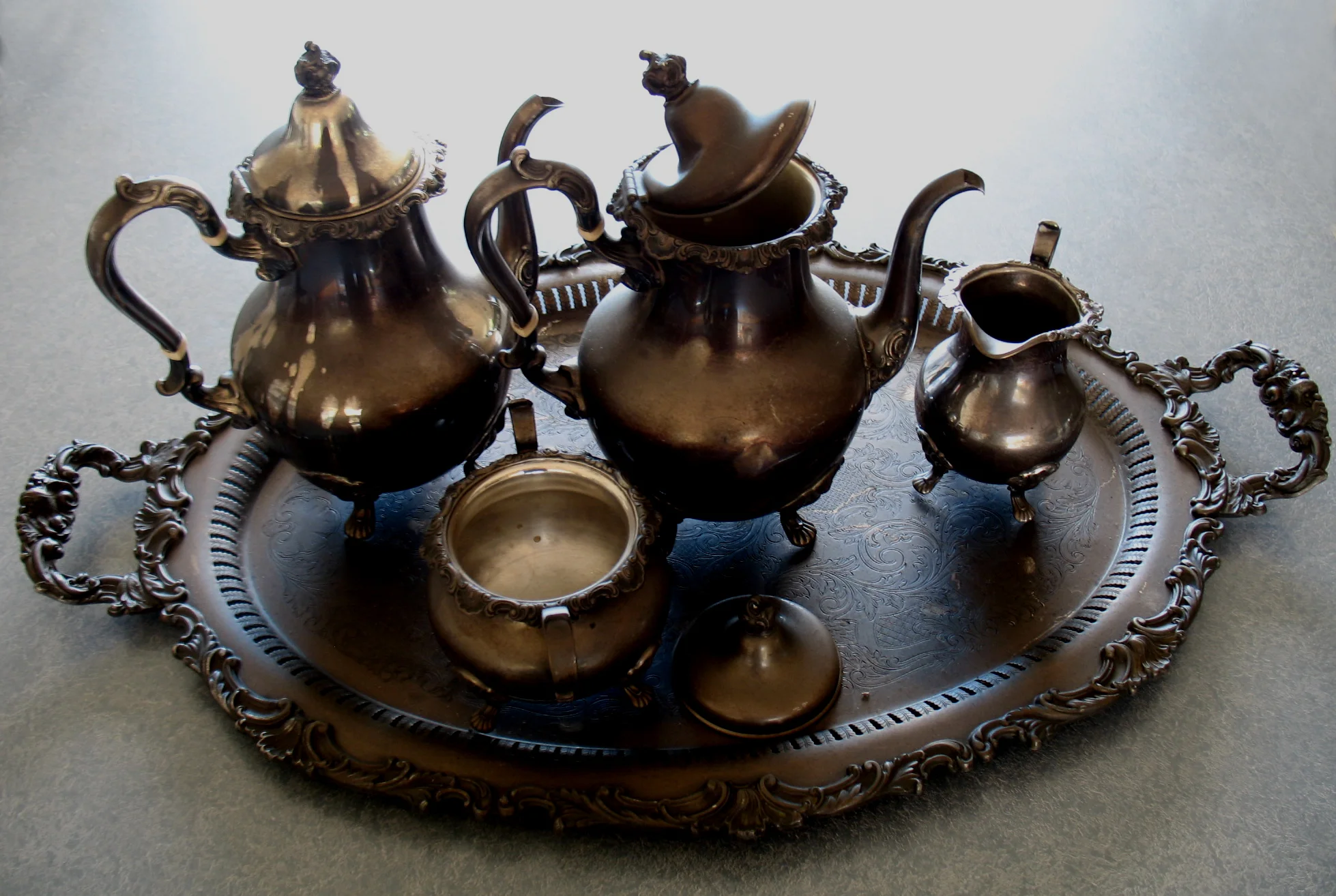 Sterling silver tea and coffee service covered with soot from fire