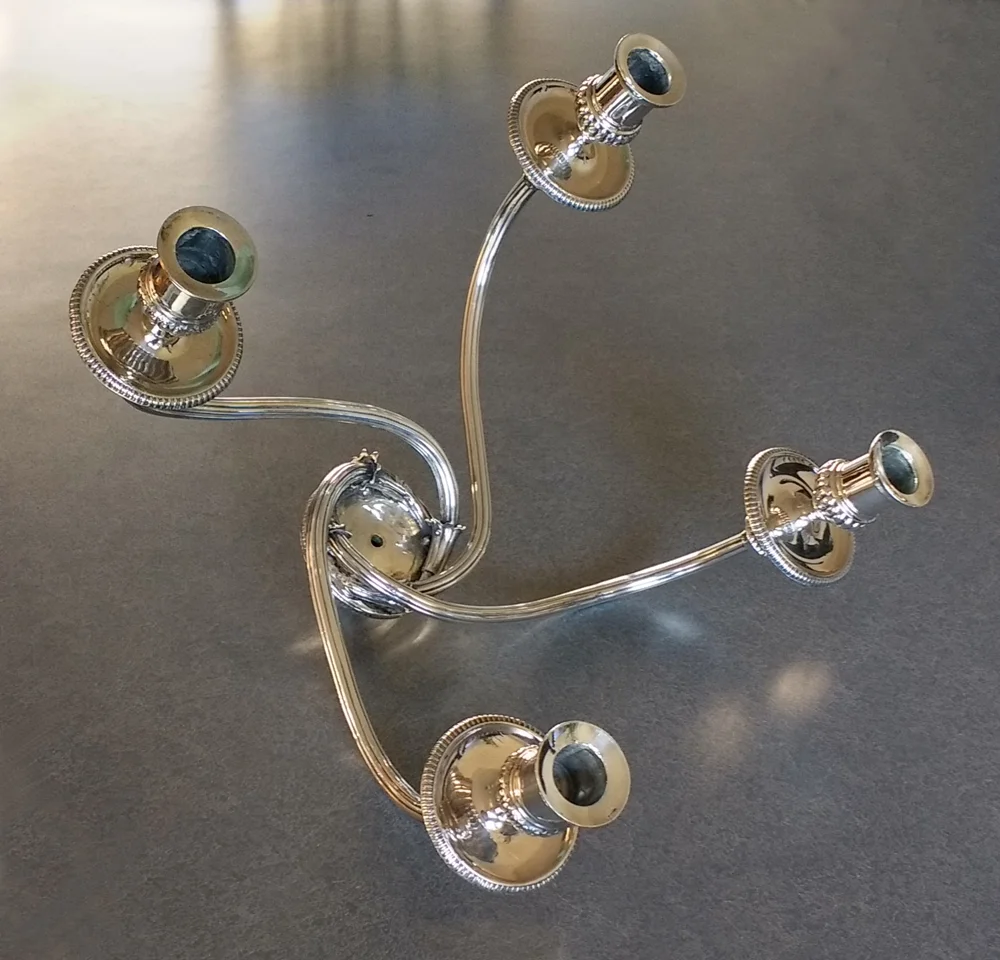 The Matthew Boulton candlestick after fixing its broken arm and polished by Harriete Berman.