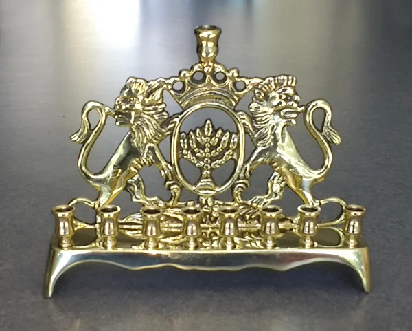 Cash brass menorah with Lion of Judah motif was repaired and polished.