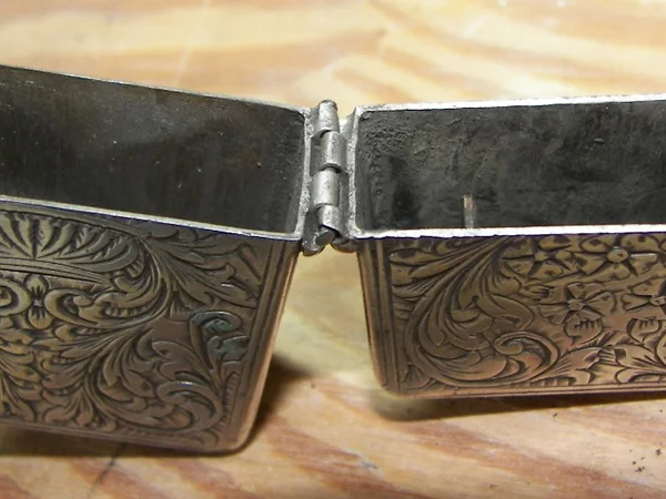 hinge broken on sterling silver cigarette lighter close-up