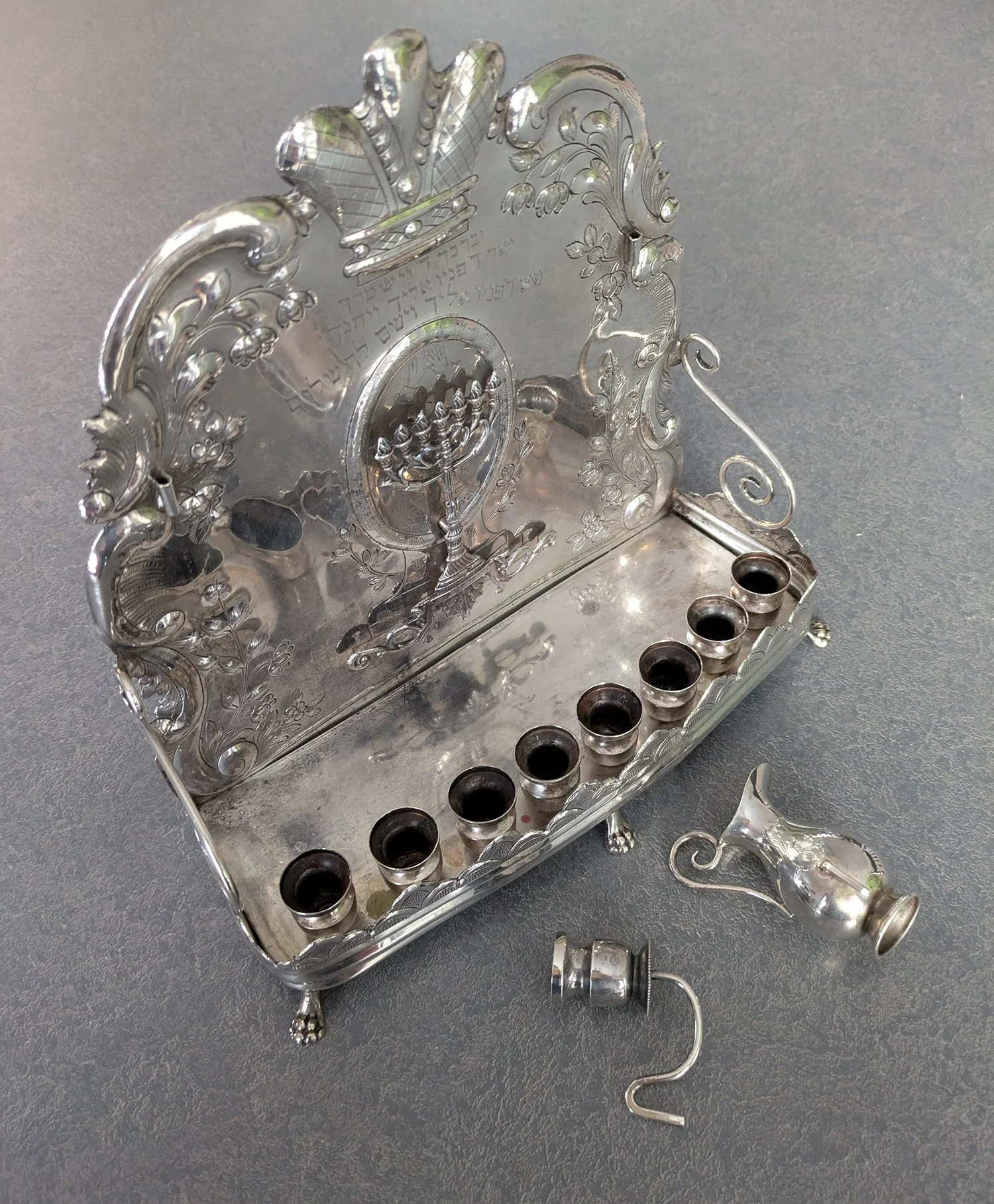 sterling silver menorah from 1920 arrived tarnished with knife scratches from removing wax, and scratches from abrasive polishing.