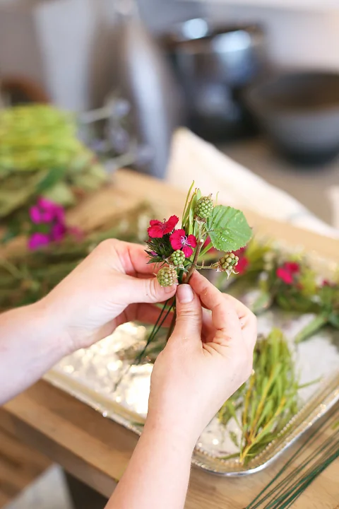 Bundle small flowers, leaves and berries together then wrap the bundle with florist tape and set aside. Continue making small bundles until you have enough to cover the entire crown.