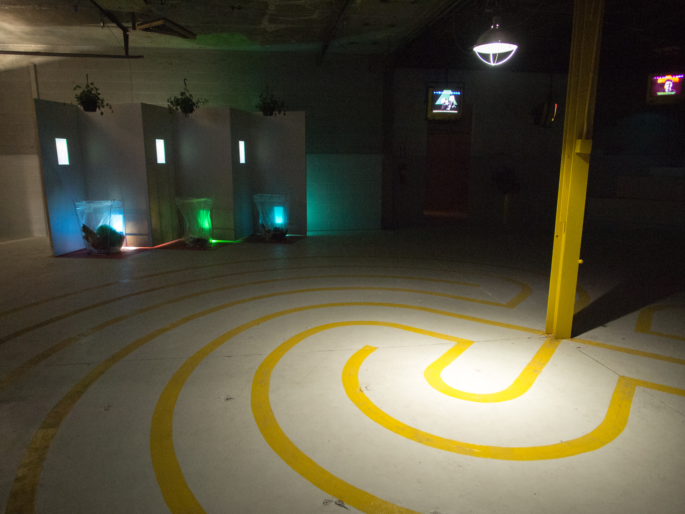 Yellow Blaze Labyrinth Dave Greber. 2016. Looped audio (14:23m), speaker pendant and amplifier, powered sub woofer, audio mixer, lamp, oil paint, water based clear polycrylic, glass beads Dimensions: 28 foot diameter
