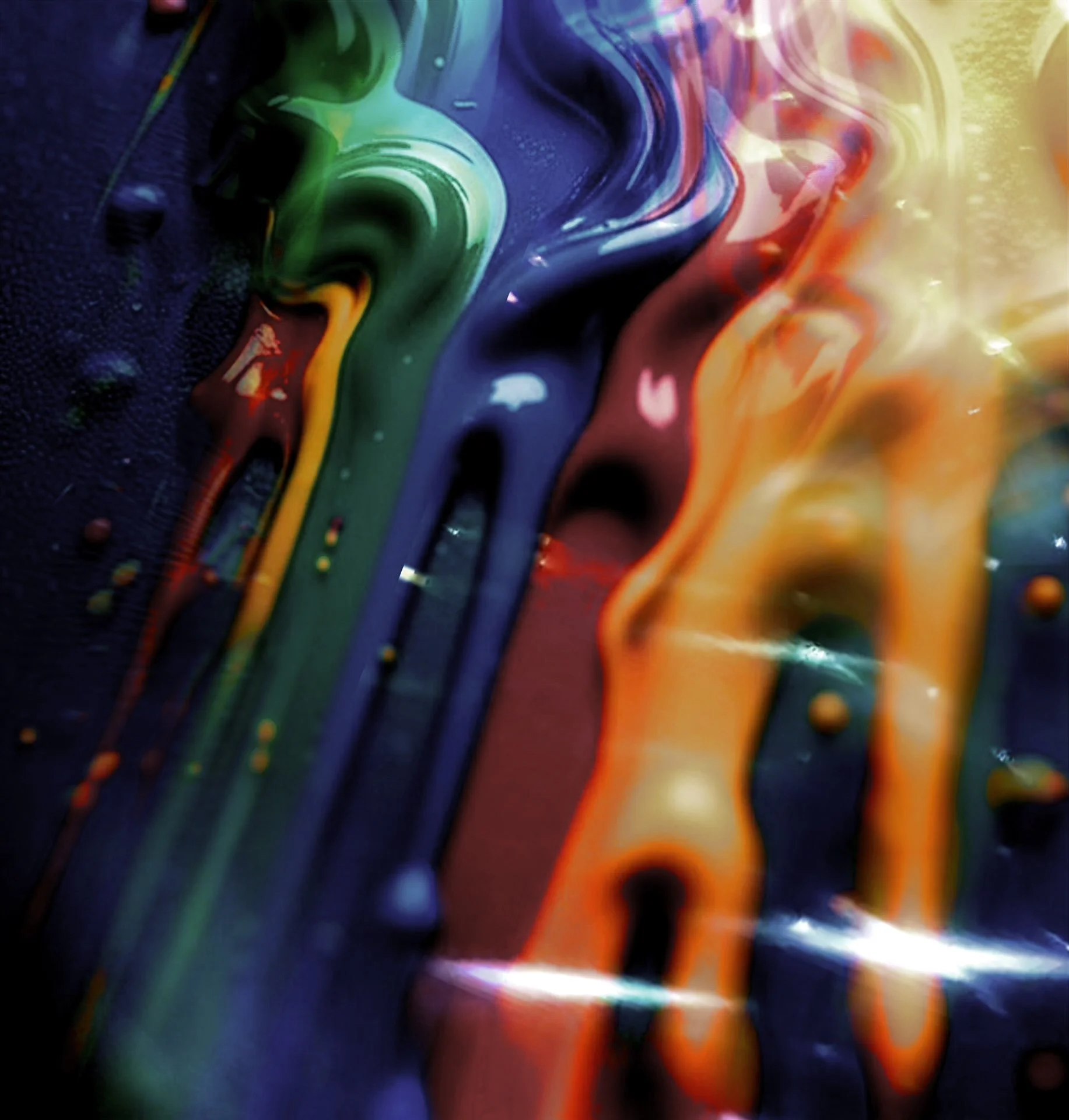 Colorful paint splattered and flowing on a black surface.