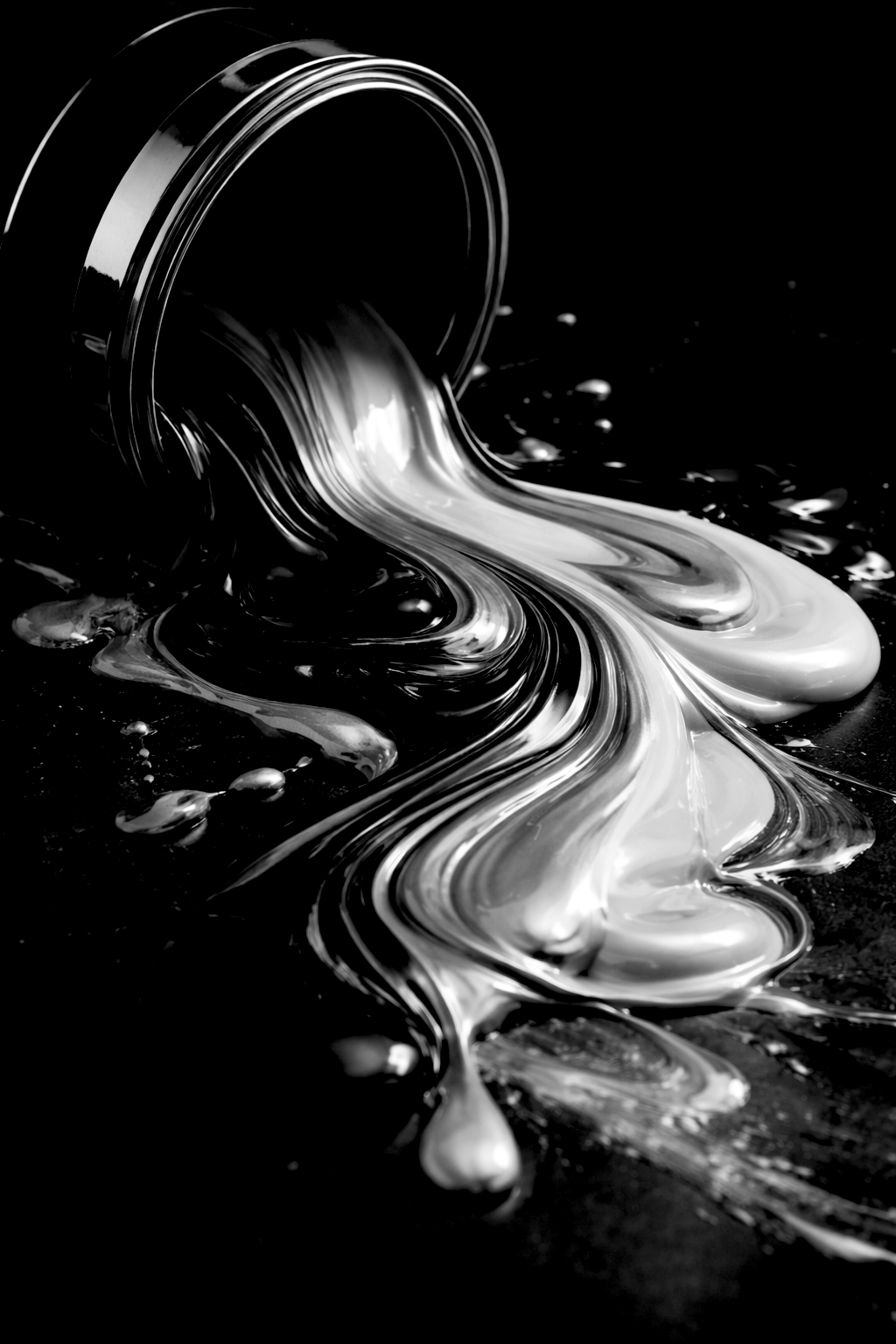 A black and white photo of paint pouring from a can, creating swirling patterns on a surface.