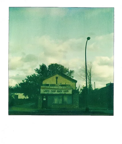 Leo’s Chop Suey Cafe (by ericarhiannon )
I took this with my SX 70 a few weeks ago when the sun light was creating some awesome shadows on this abandoned restaurant. I had to mess with the scan a bit as the original is slightly flat. They just tore this place down a few days ago.