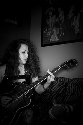 Ypsi Project : Liann Castillo (via ericarhiannon )
A few weeks ago I was chatting with my friend Liz about the Ypsi Project, among other fun stuff, and she decided to call up her friend Liann who lives in Ypsi and ask if she would let me take her photo. She agreed and I met up with her at her house tonight. Liann was super nice and very patient while I turned what was suppose to be a quick session into a long session. She played a little bit while I was snapping away, and despite her complaints that the guitar was out of tune it sounded just fine to me. She plays bass for Gore Gore Girls and Gorevette . I had never listened to her music before meeting tonight, but I have now and it impressed me enough to want to go to their show on the 28th of this month. She also loves sharks- collecting them and even making them on her sewing machine. My favorite of her collection was Lumpy, he wears a sharp little sweater.