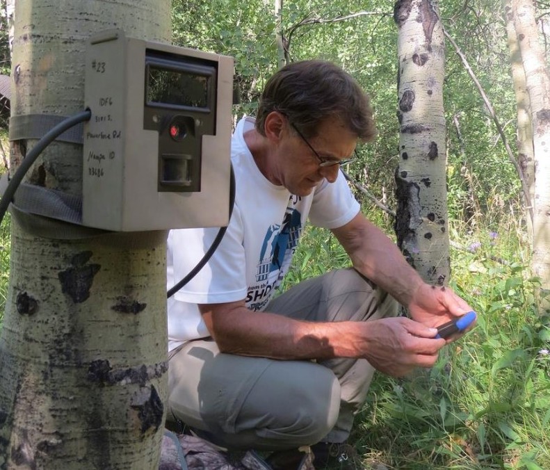 Kris Thoreson, the WRWP Field Manager, setting up a camera trap and recording the GPS coordinates in the Project Area. Photo Credit: Lauren Hennelly