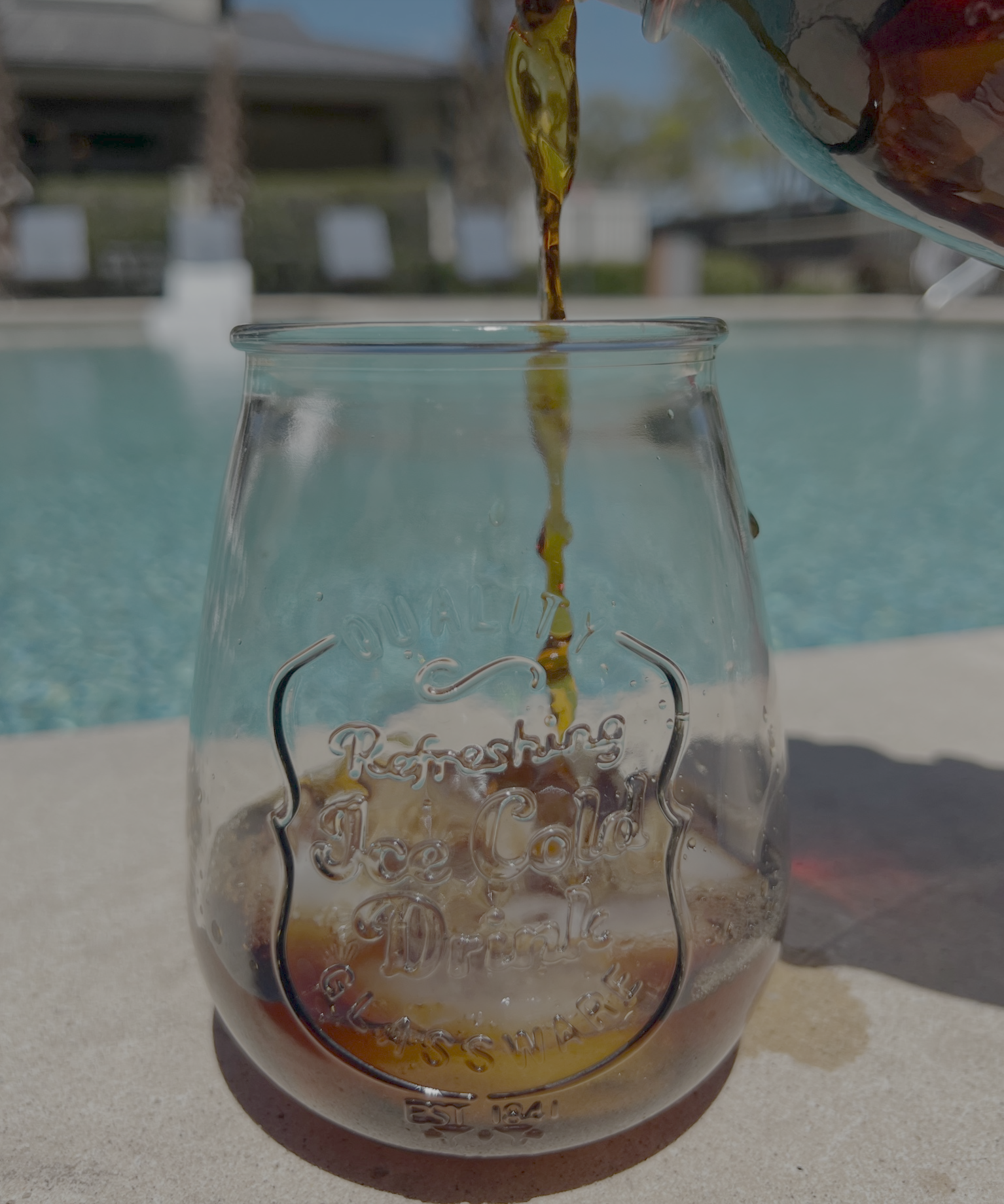 Cold coffee by swimming pool.png