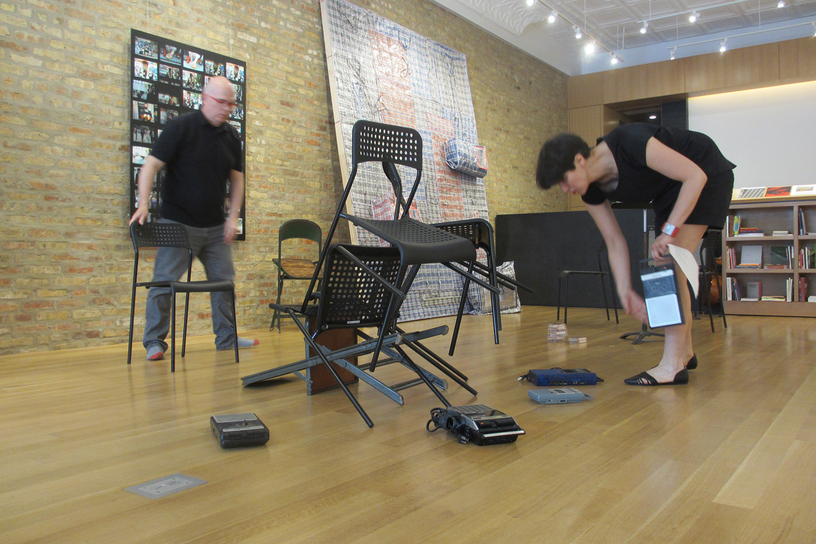  Mark Booth and Becky Grajeda,  Duet Kcotsdoow (For Bodies, Stackable Chairs, Tape Recorders, Cassette Tapes,  Voices, and Instruments),  Performance, 2015 