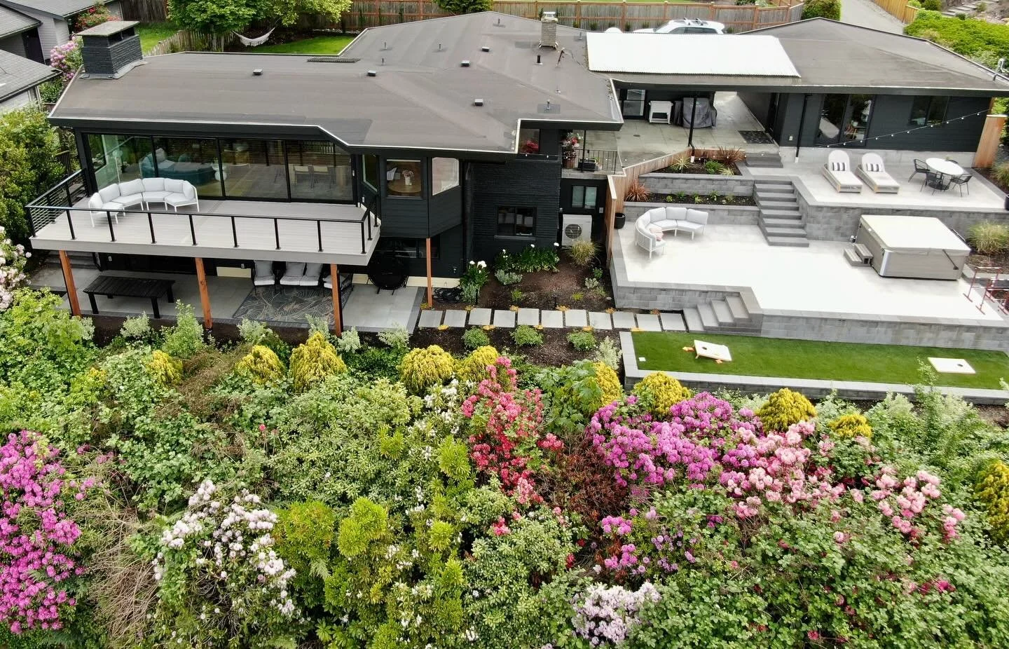 One of our favorite outdoor living transformations in Edmonds.

The goal was creating multiple connected outdoor living spaces while keeping the view completely unobstructed.

The upper deck is accessed through a full NanaWall glass system &mdash; me