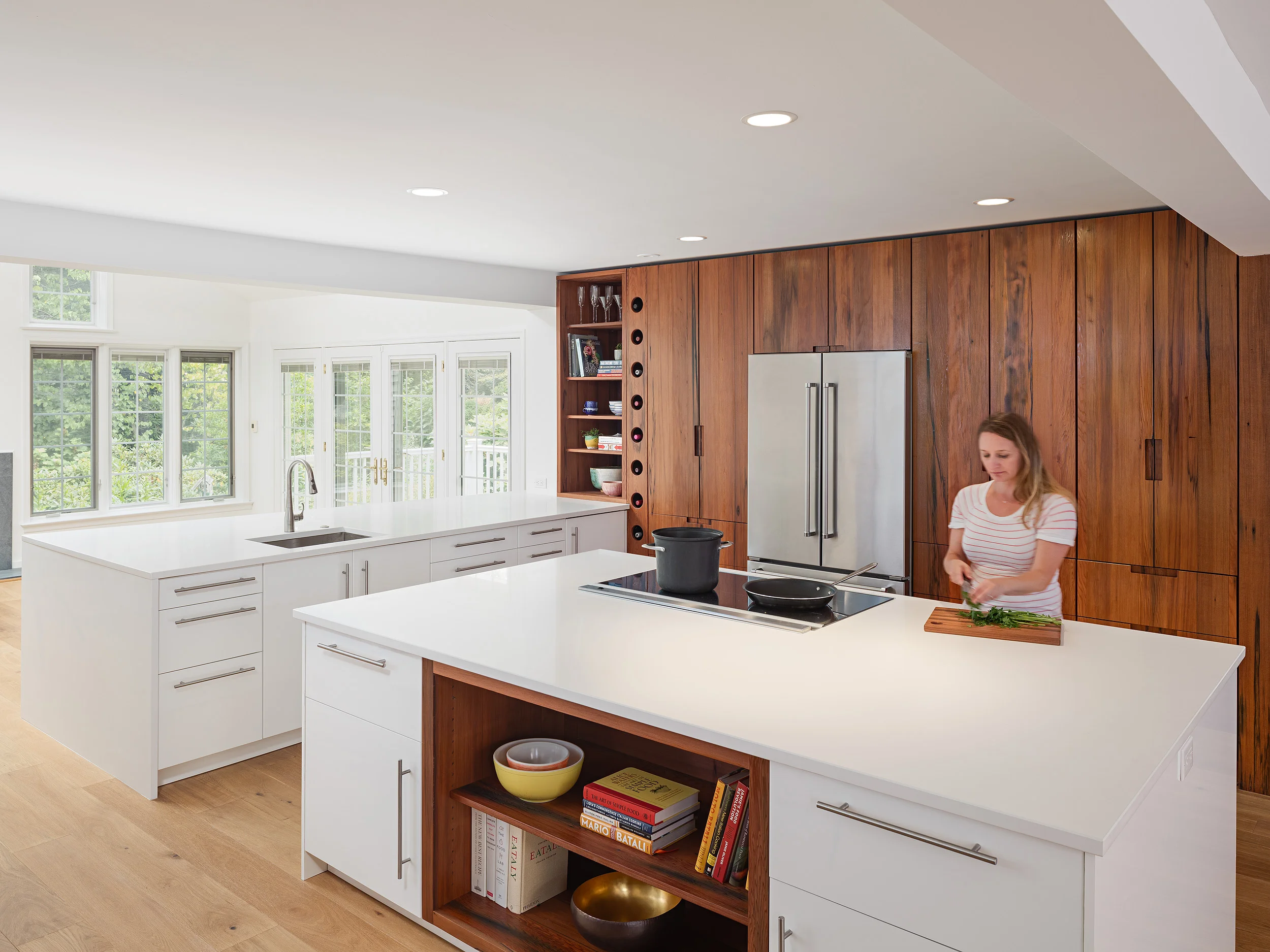  In the kitchen, we unearthed some of our favorite reclaimed American redwood to make a bold statement with the cabinetry.&nbsp; Using flat panels and integrated handles on the cabinet fronts, we allowed the redwood’s extraordinary grain and depth of