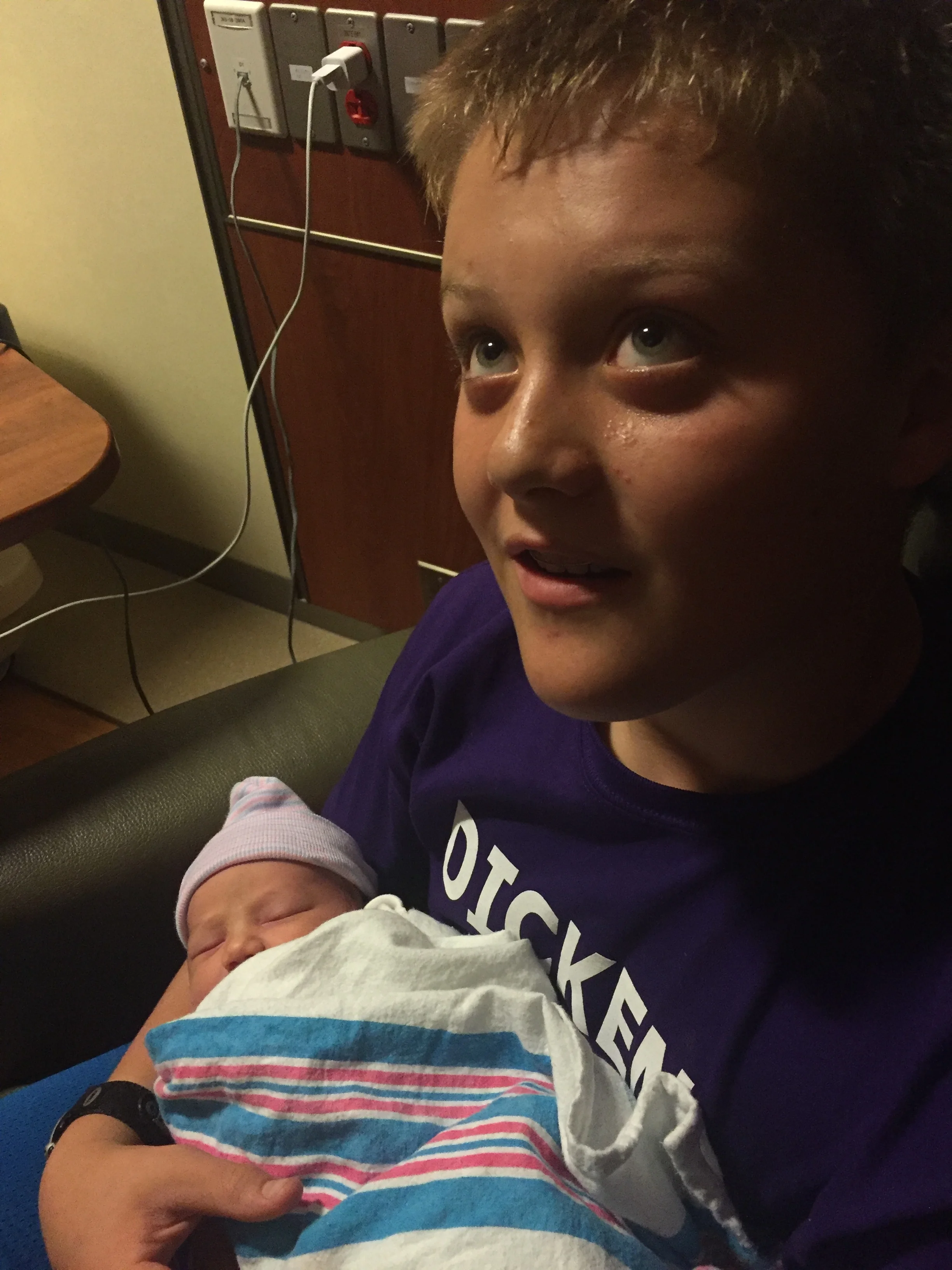 Liam holding baby Henry for the first time.