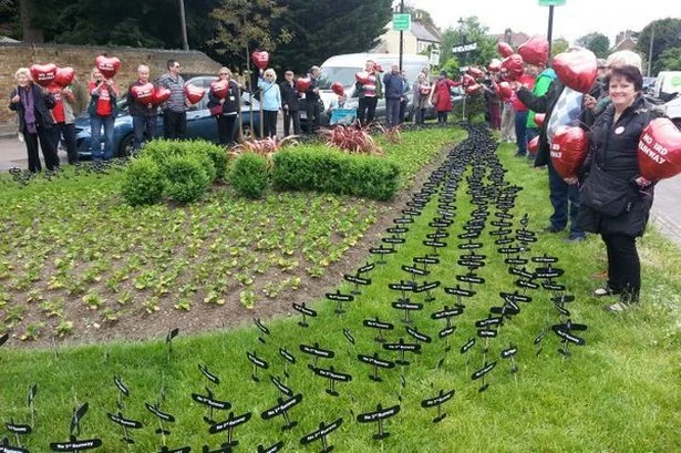 Formation of black aircraft on Harmondsworth village green