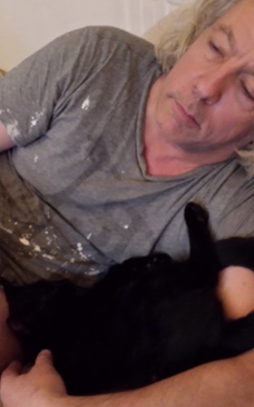 Relaxing with Paddy the cat after a hard day's work