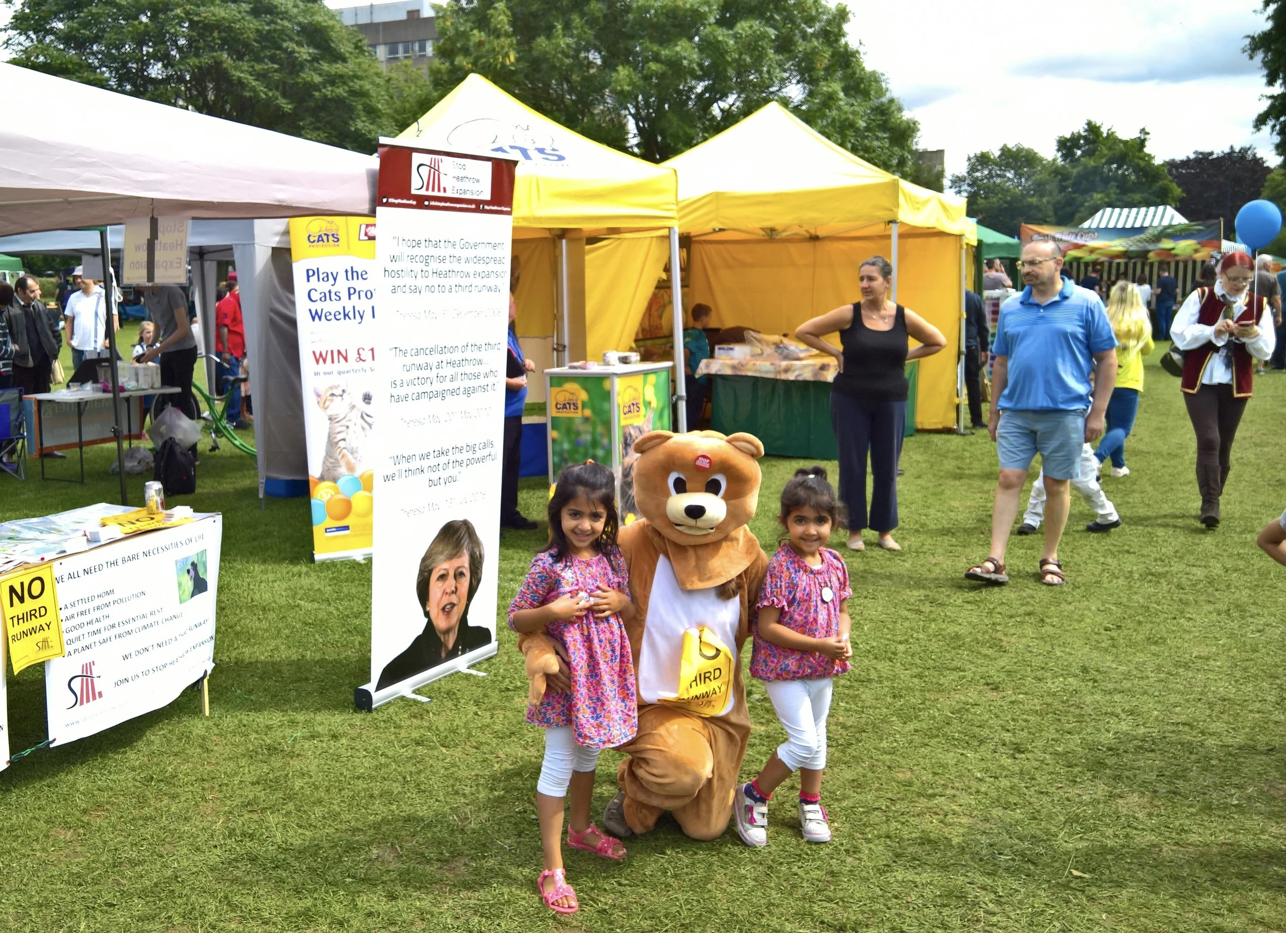 Watch out girls! The bear is friendly but that nasty Theresa May is right behind you!