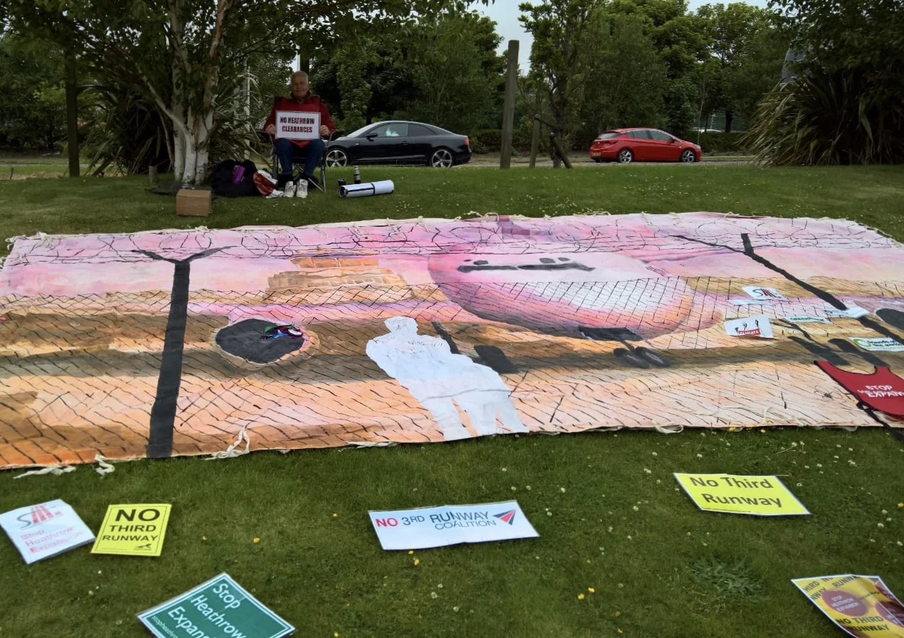 Airport boundary mural, campaign signs and Uncle Ray with his "No Heathrow Clearances" protest.