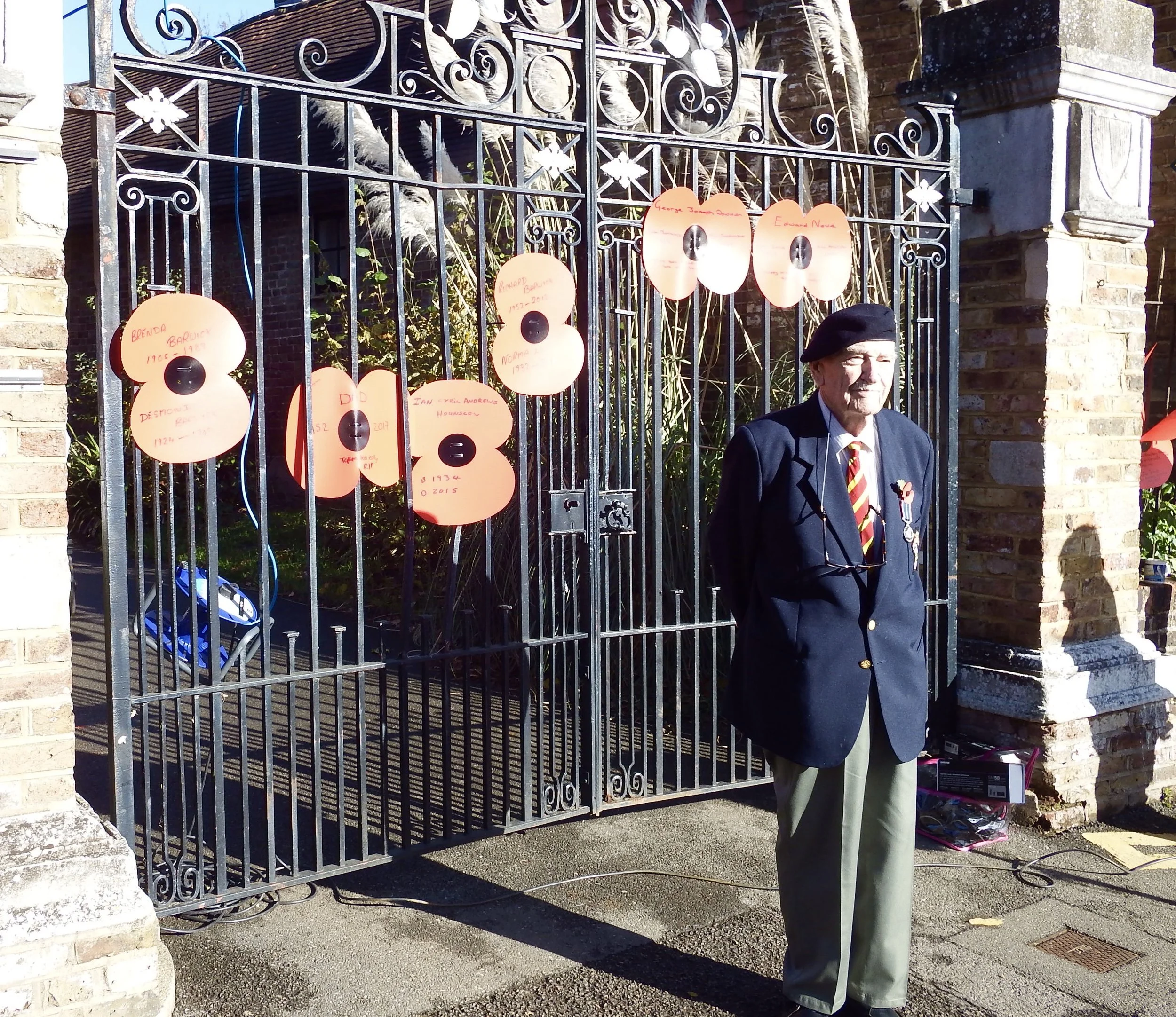Roy Barwick outside the church gates with their poppies of remembrance