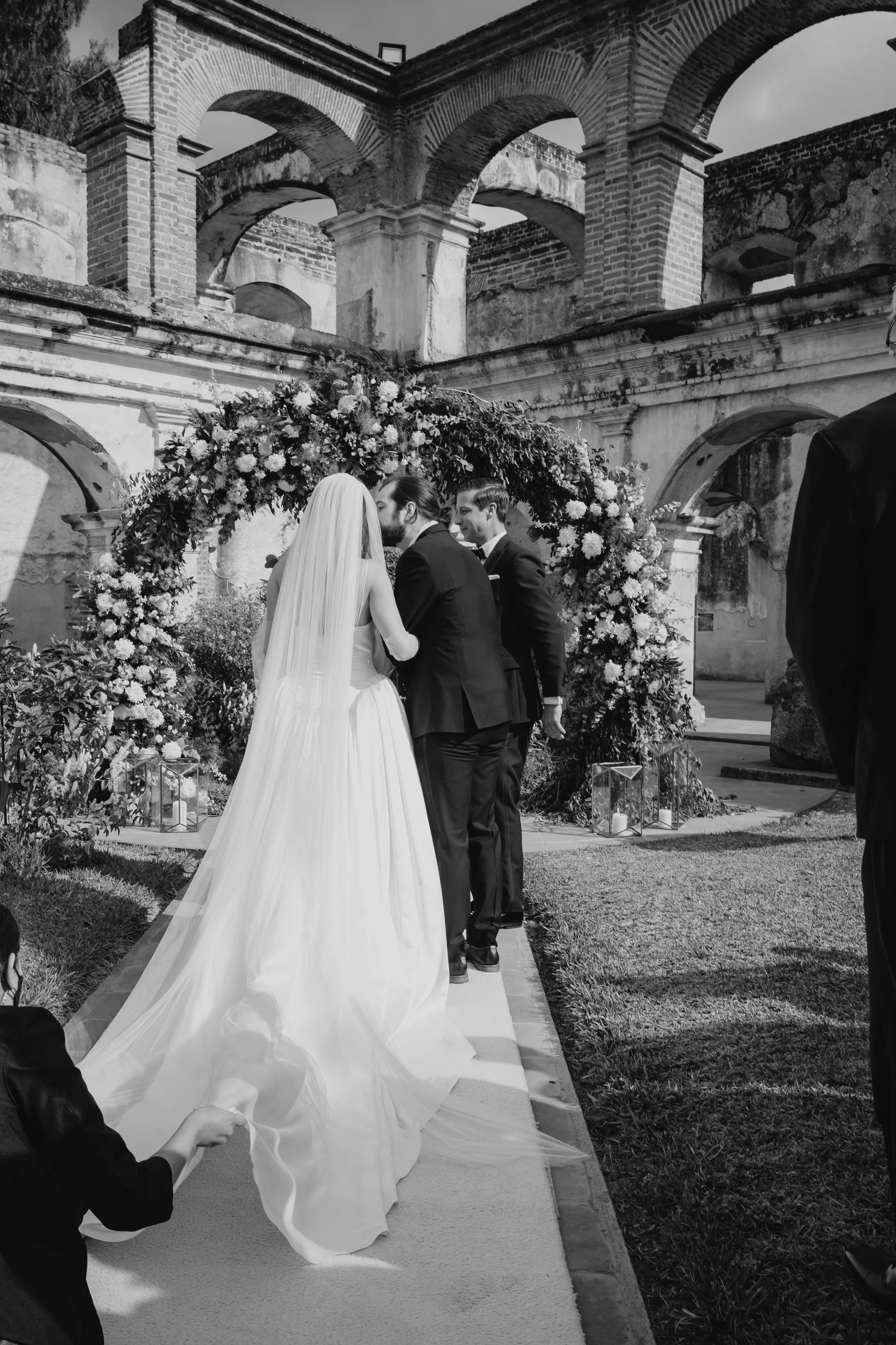 Outdoor wedding ceremony at Santa Clara Ruins surrounded by historic colonial architecture in Antigua Guatemala.
