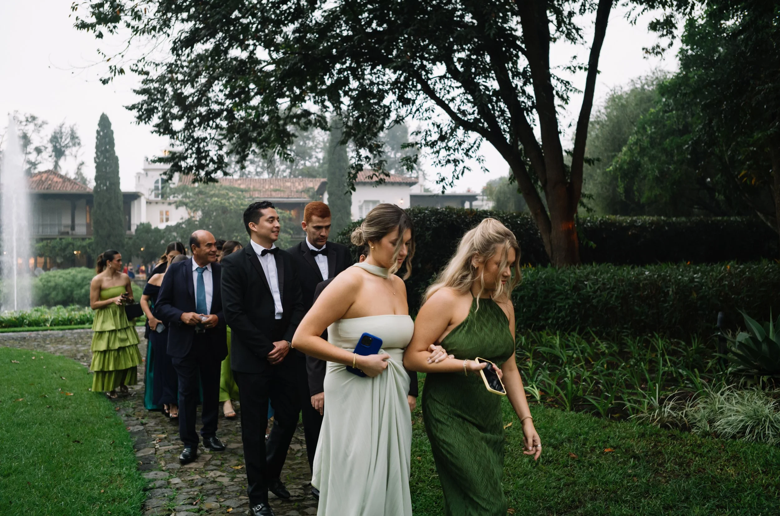 Guests arriving during a luxury rainy season destination wedding reception at Villa Bokeh in Antigua Guatemala.