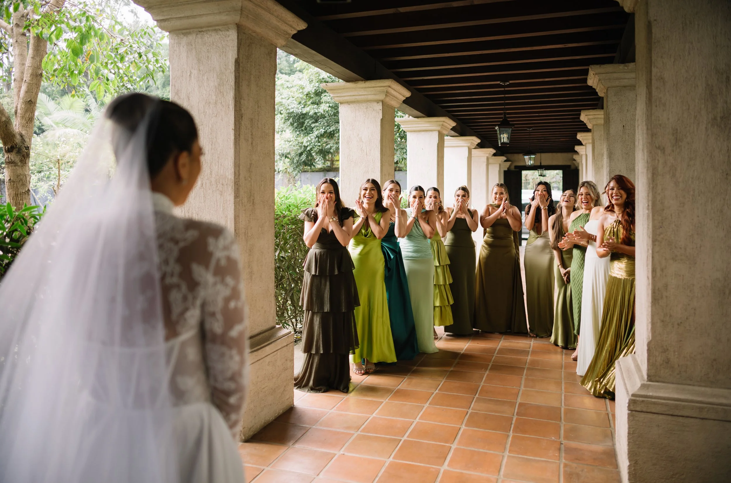 Bride sharing a first look with her bridesmaids at Villa Bokeh before her destination wedding in Antigua Guatemala.