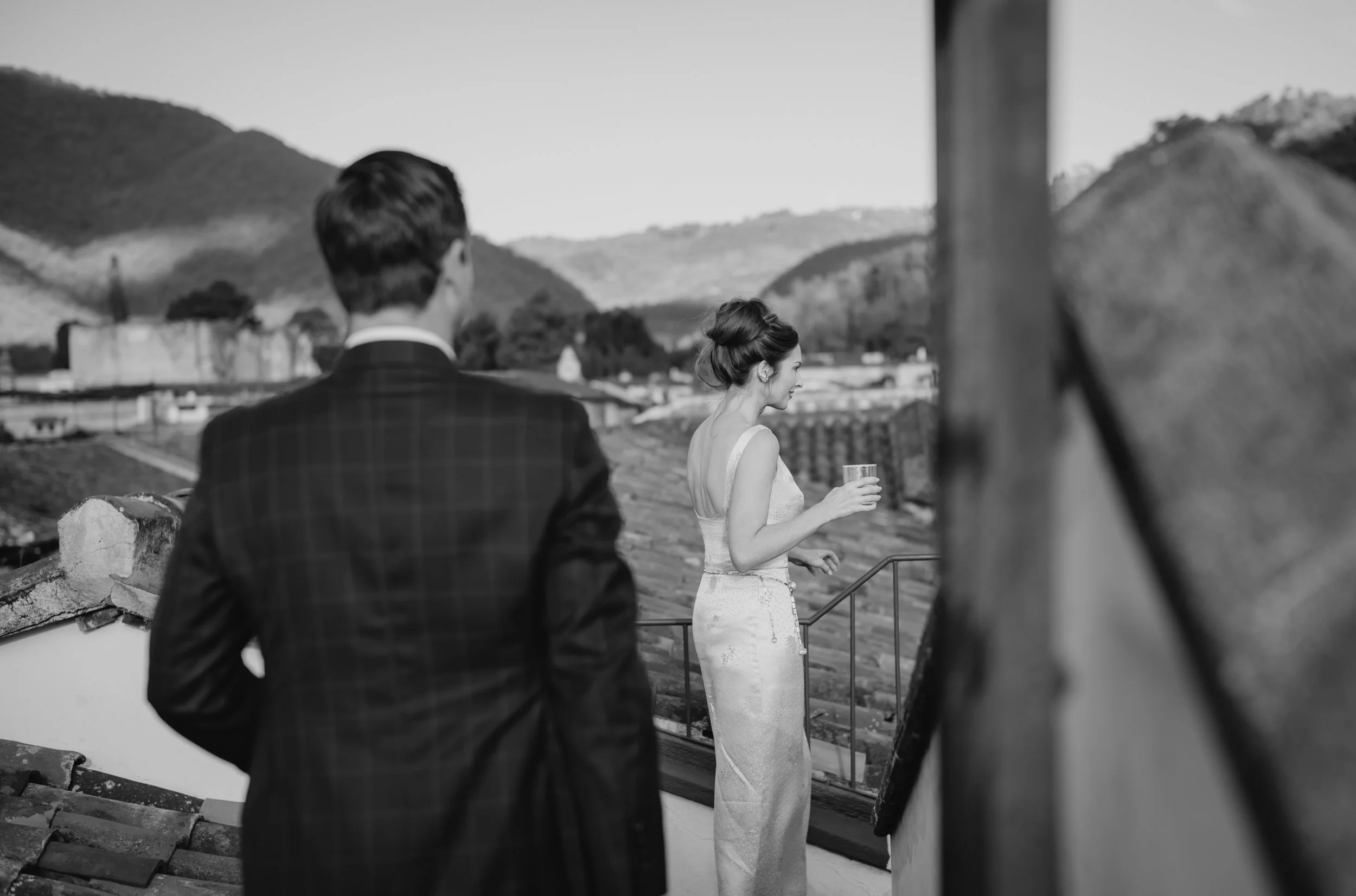 Bride and groom walking through Antigua Guatemala with Volcán de Agua in the background after their wedding ceremony.