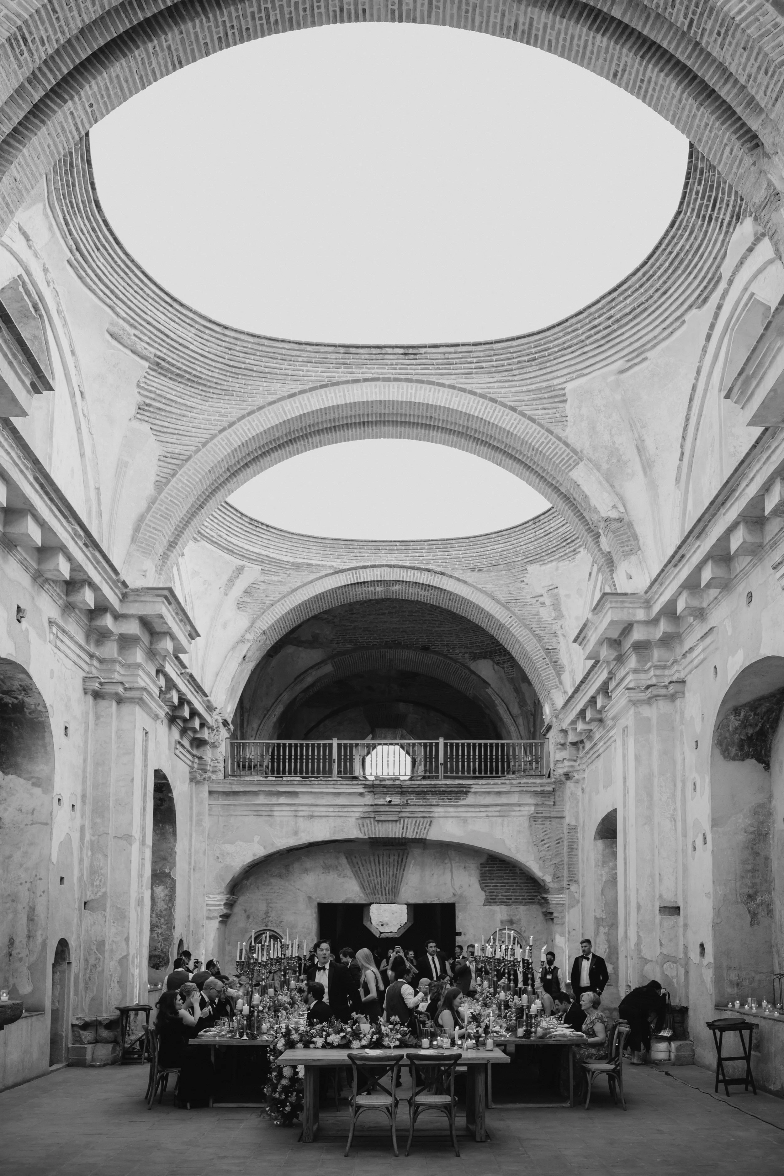 Wide architectural wedding photograph inside the historic Santa Clara Ruins in Antigua Guatemala.