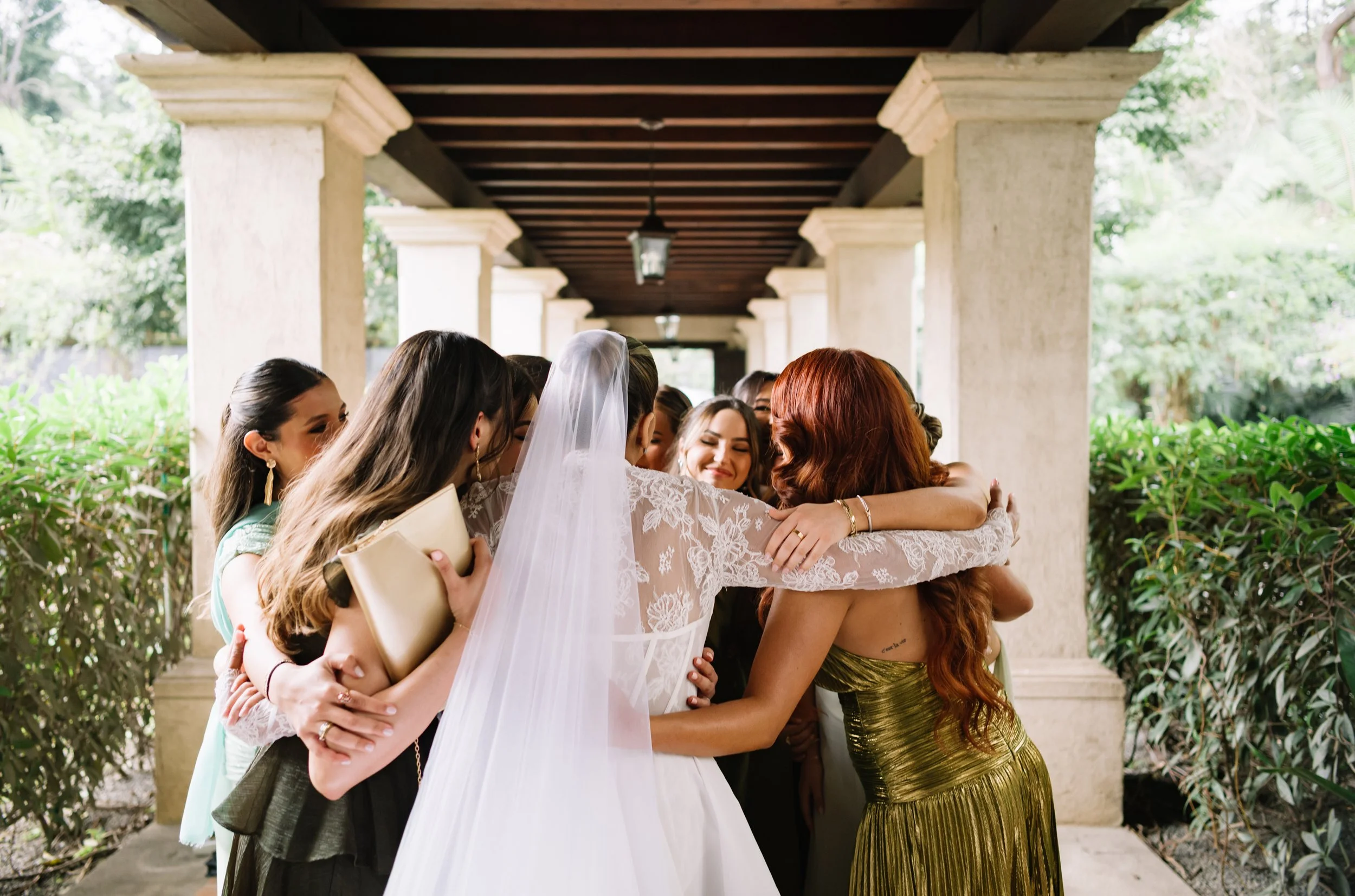 Brides first embrace with her bridesmaids at Villa Bokeh before her destination wedding in Antigua Guatemala.