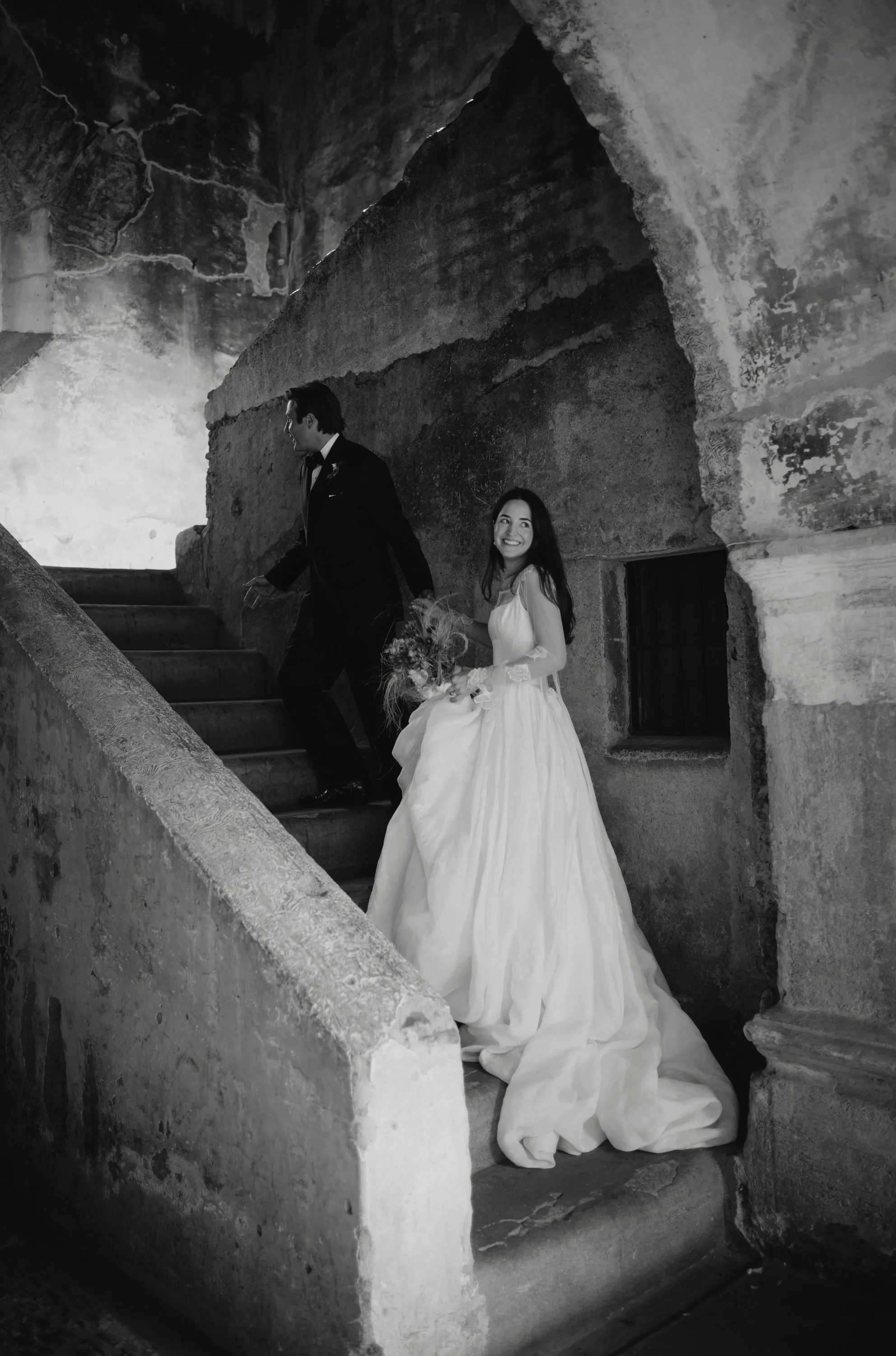Couple portrait beneath historic archway in Antigua Guatemala