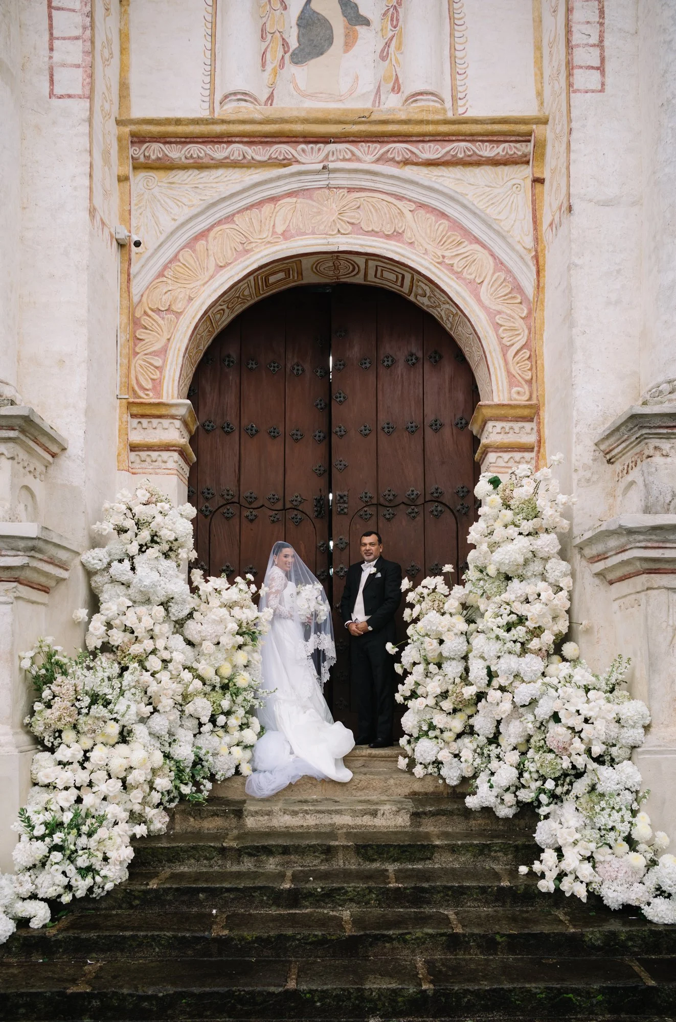 Bride and father before destination wedding ceremony at San Juan del Obispo Church.