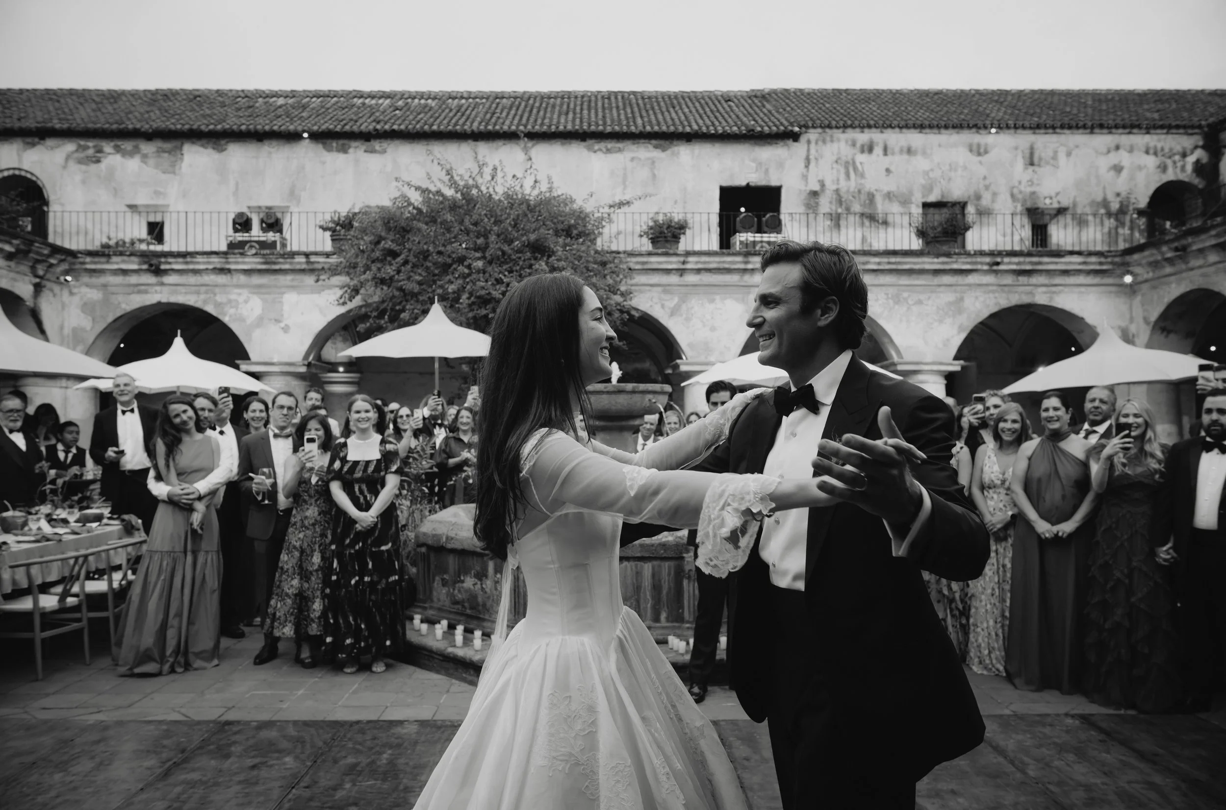 Bride and groom sharing their first dance in black and white photography