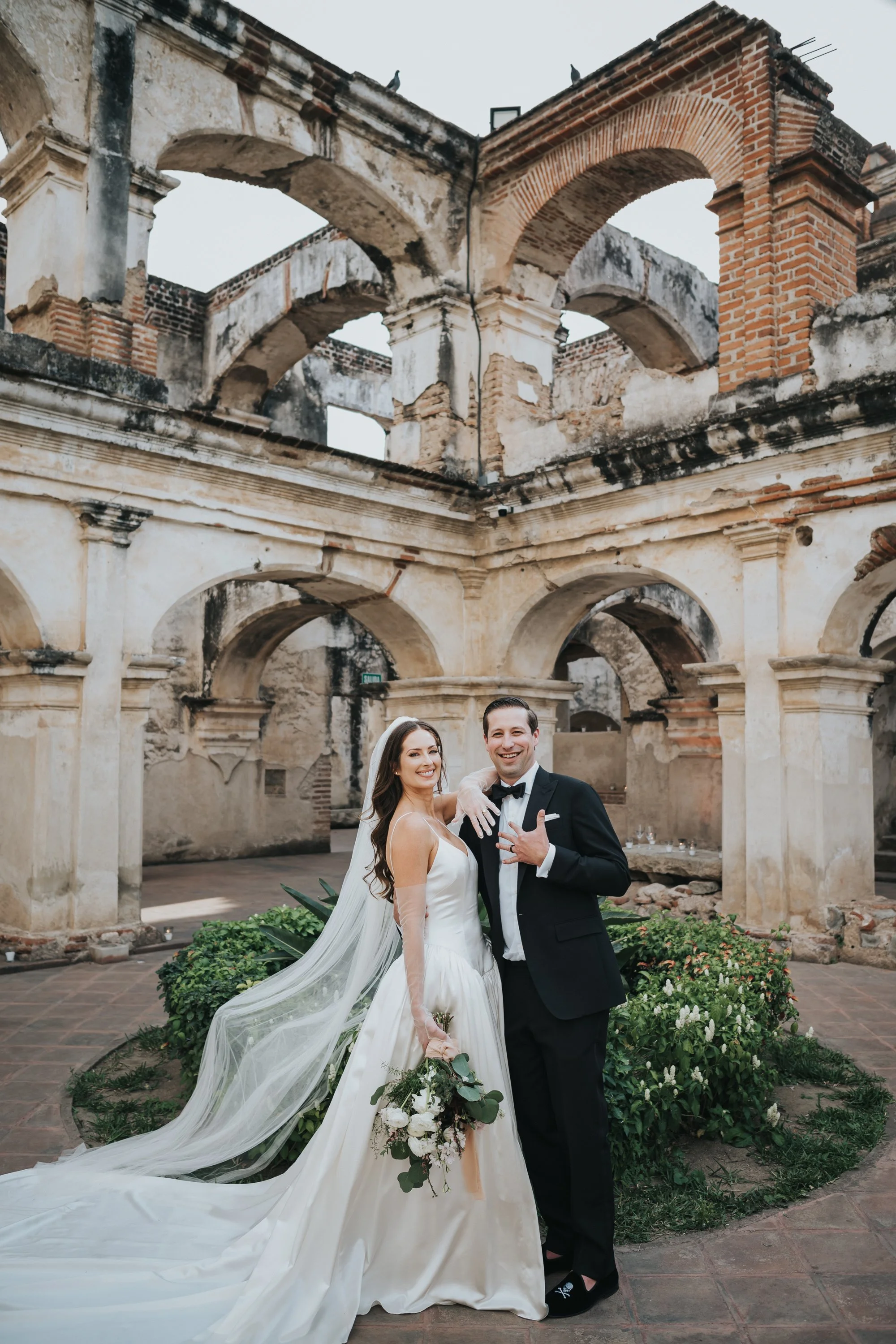 Editorial bride and groom portraits photographed among the historic architecture of Antigua Guatemala.