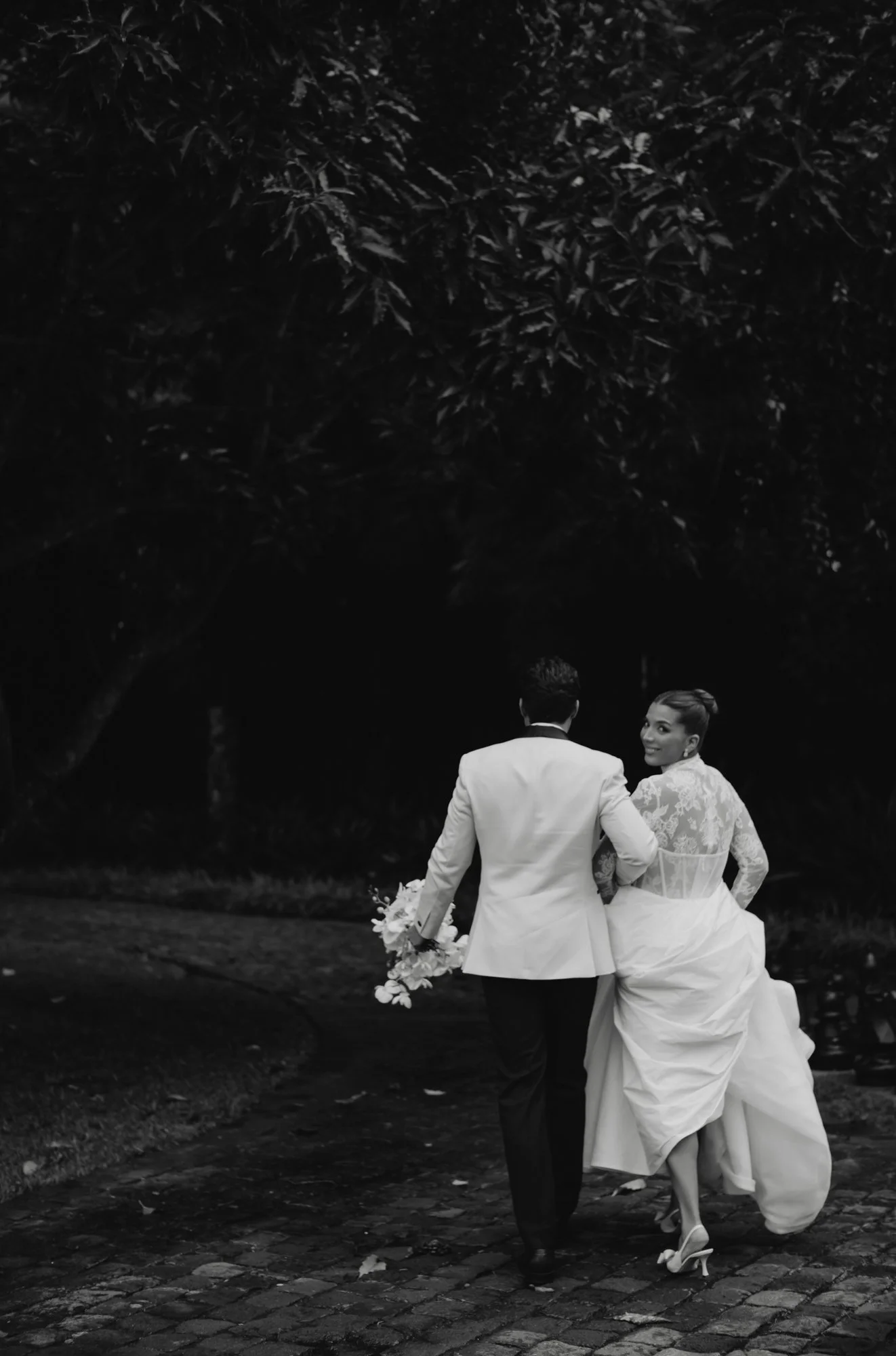 Bride and groom embracing in the rain during an October destination wedding in Antigua Guatemala.